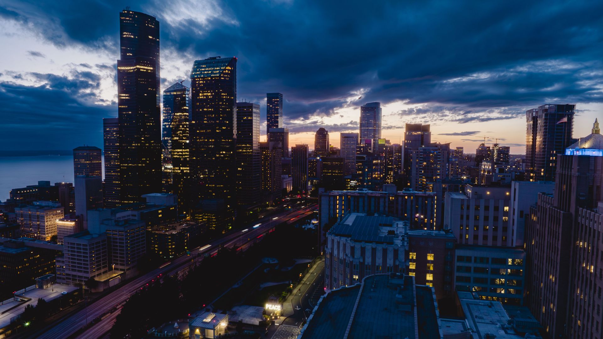 The city of Seattle seen from the air with a dark sky at dusk. 
