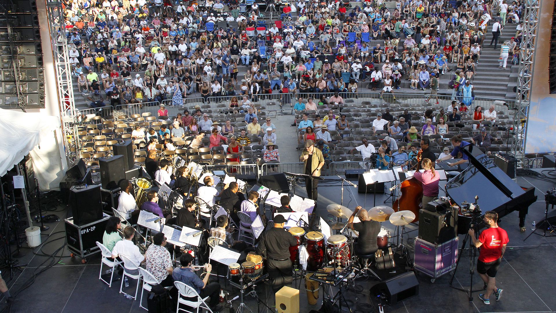 A crowd for Detroit Jazz Fest. The band is shown in front, with onlookers beyond.