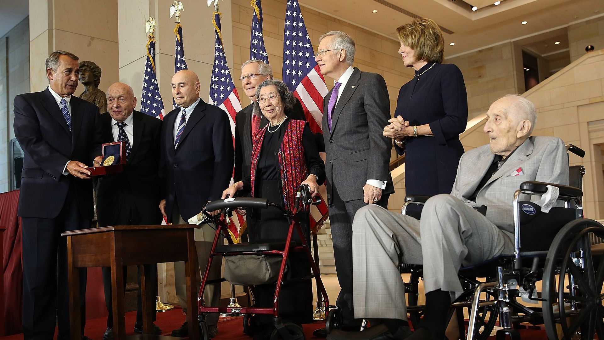John Boehner presenting a medal to group of Monuments Men and Women, alongside fellow members of Congress. 