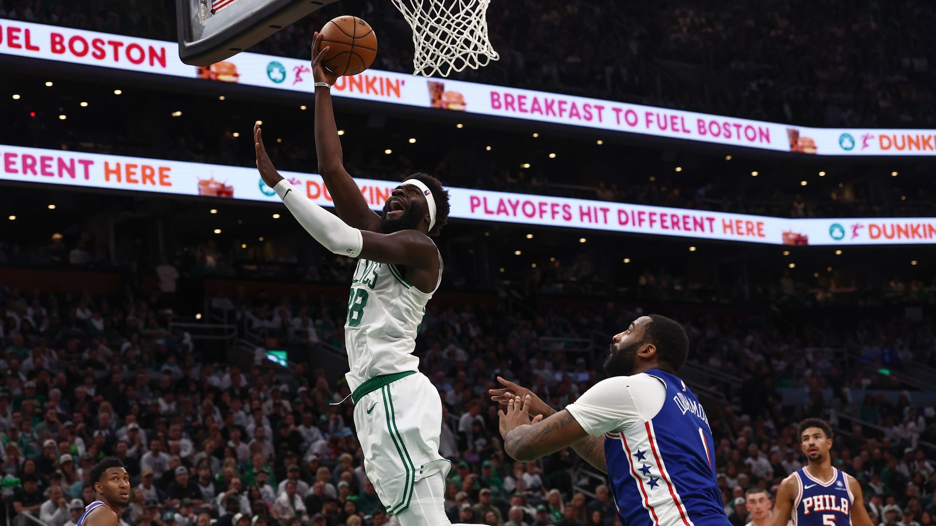 Neemias Queta #88 of the Boston Celtics lays the ball up past Andre Drummond #1 of the Philadelphia 76ers during the second half of Game One of the Eastern Conference First Round NBA Playoffs at TD Garden on April 19, 2026 in Boston.