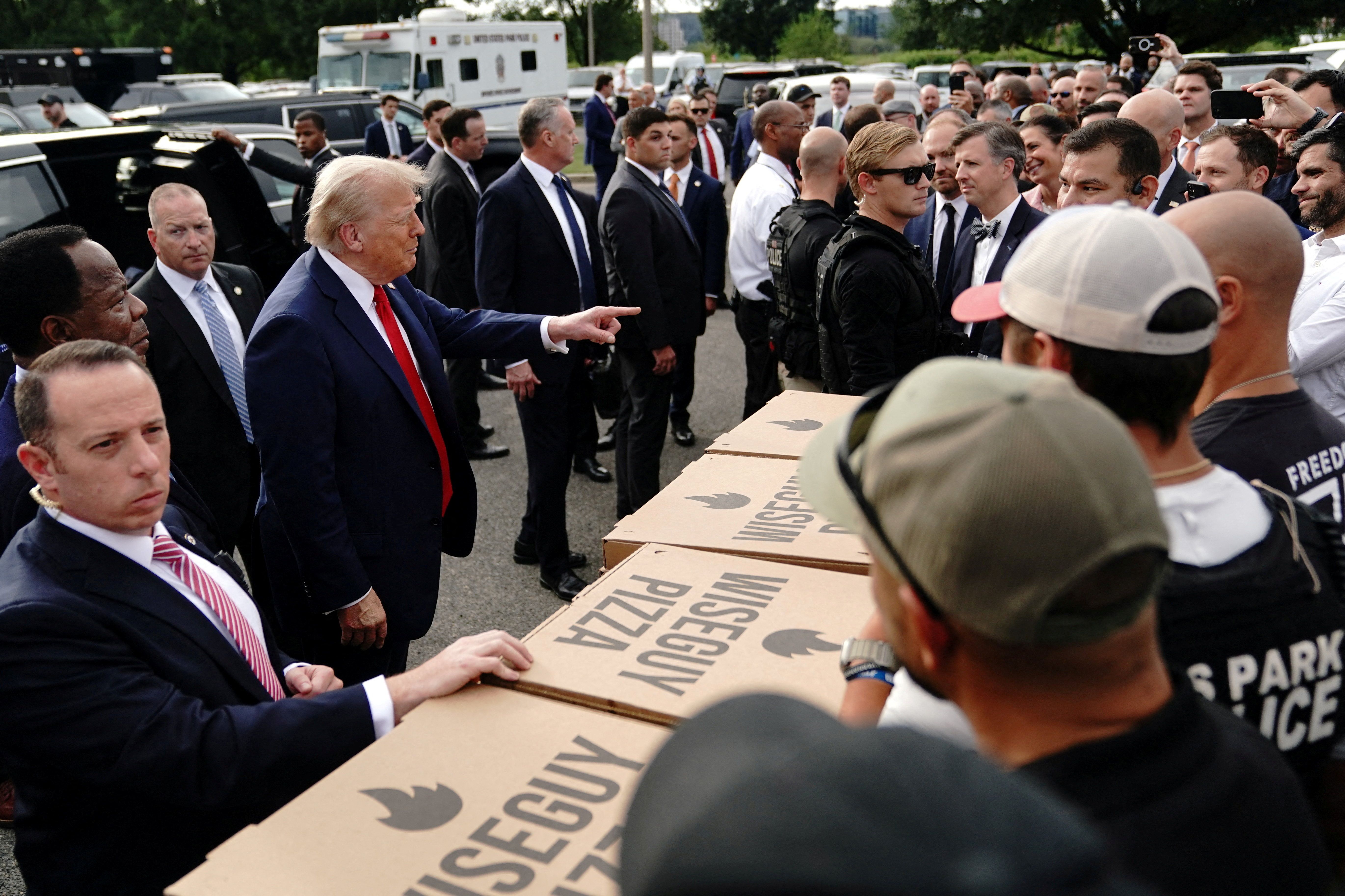President Trump handed out pizza and burgers he said were made at the White House as he visited Park Police Anacostia Operations Facility to meet with police and the military, after deploying National Guard troops in D.C.