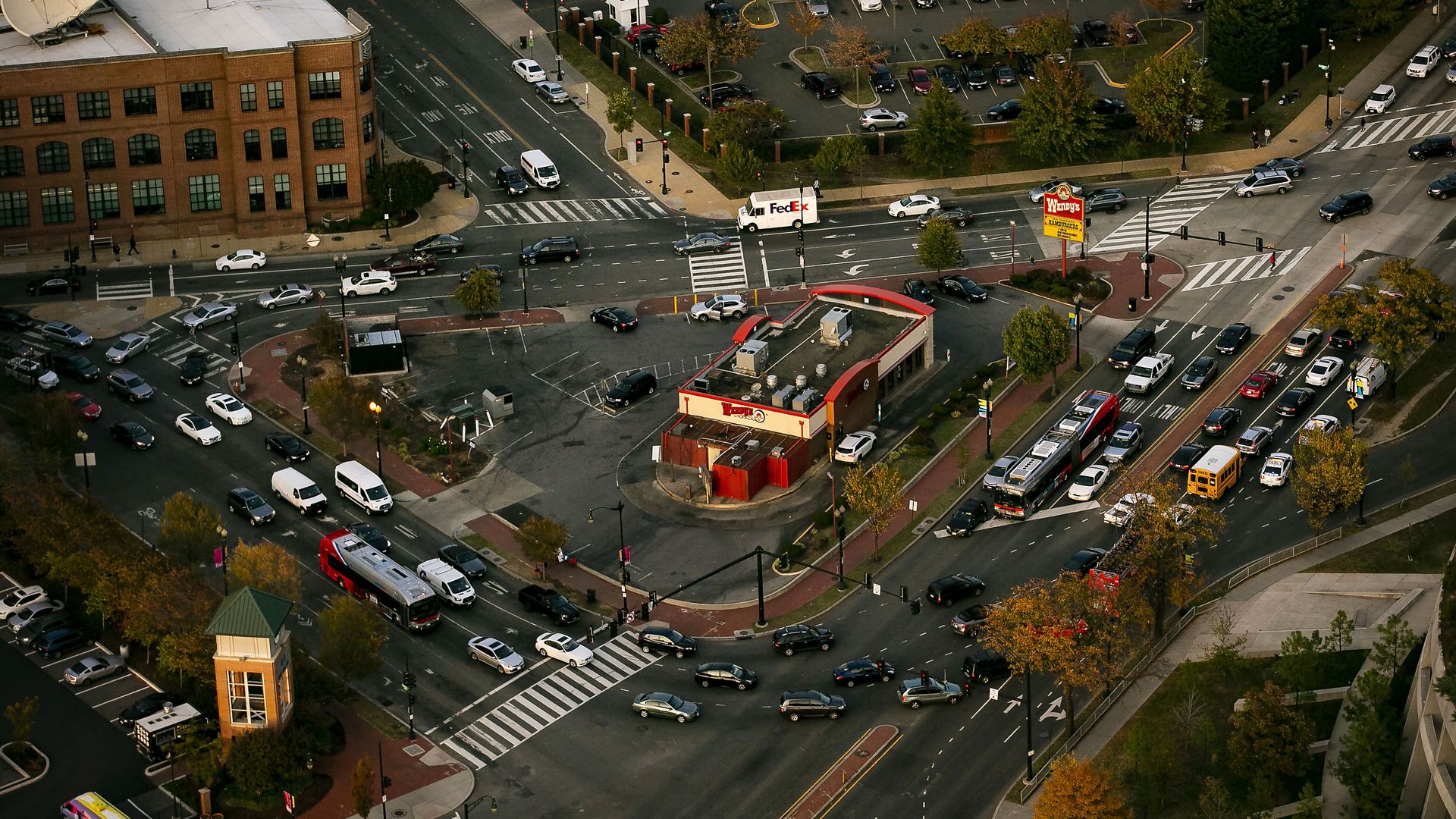 An aerial view of cars driving through Dave Thomas Circle, with the Wendy's in the middle.