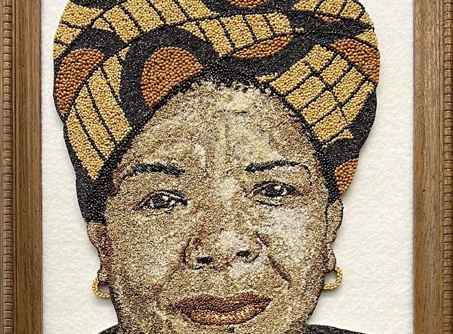 A seed-art depiction of Maya Angelou made with 14 different types of seeds
