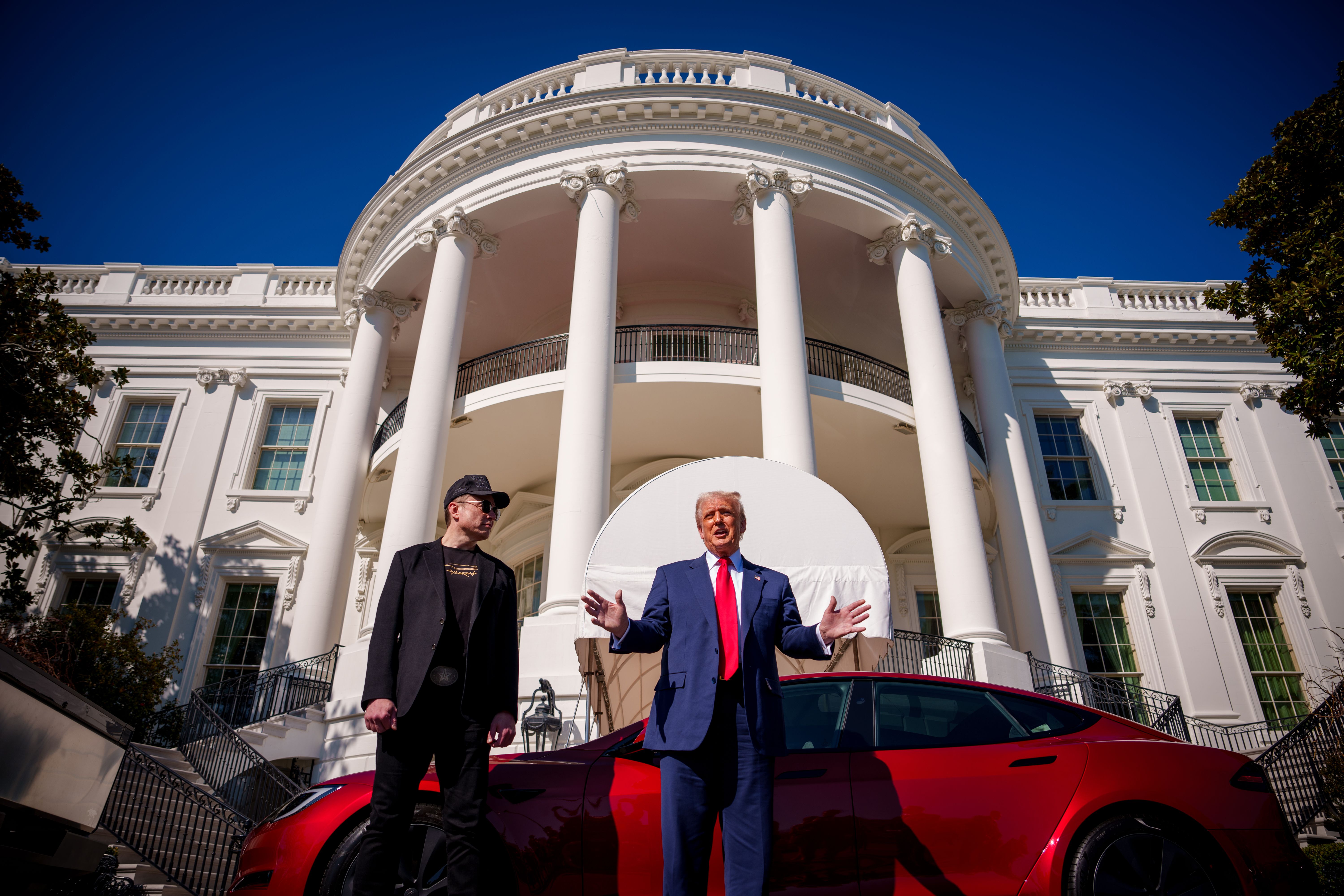 Elon Musk and President Trump stand in front of a range of Tesla models on the South Lawn last month.