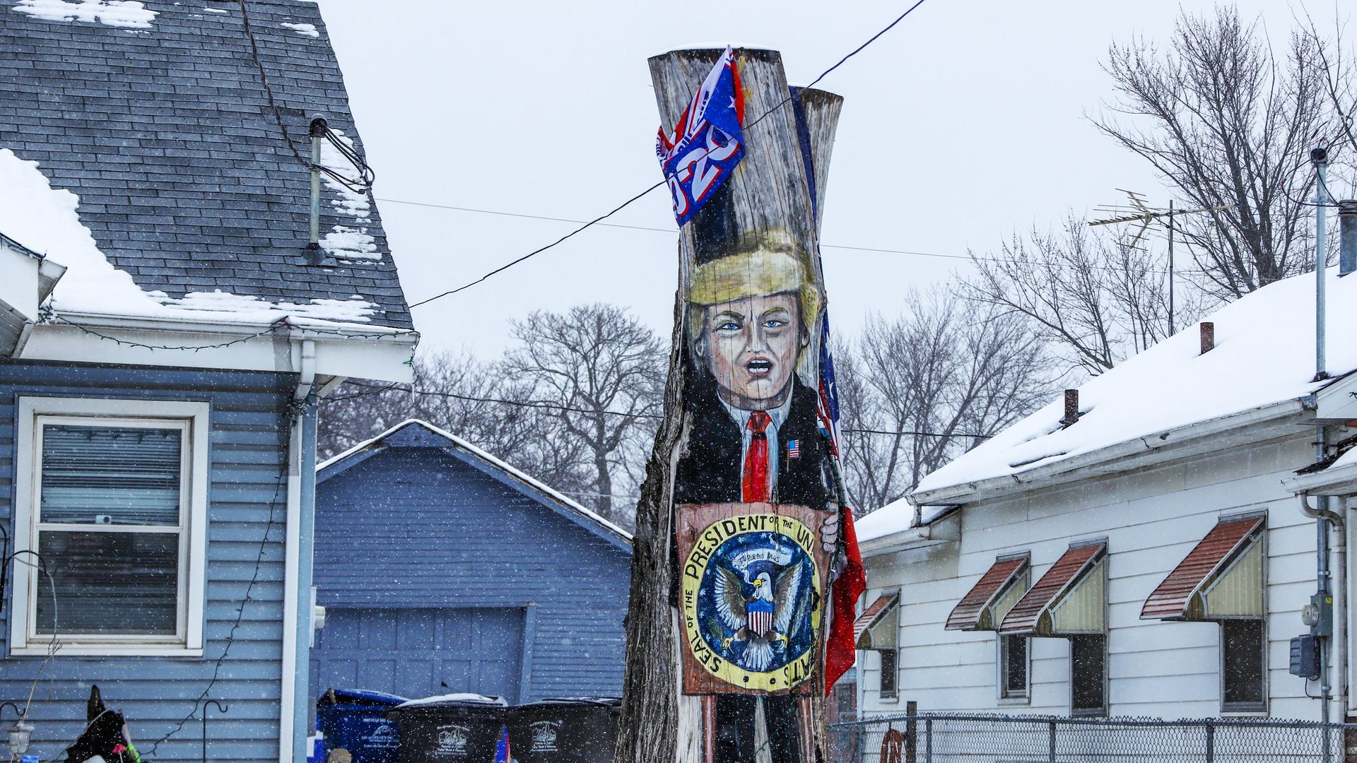A tree stump painted with trump