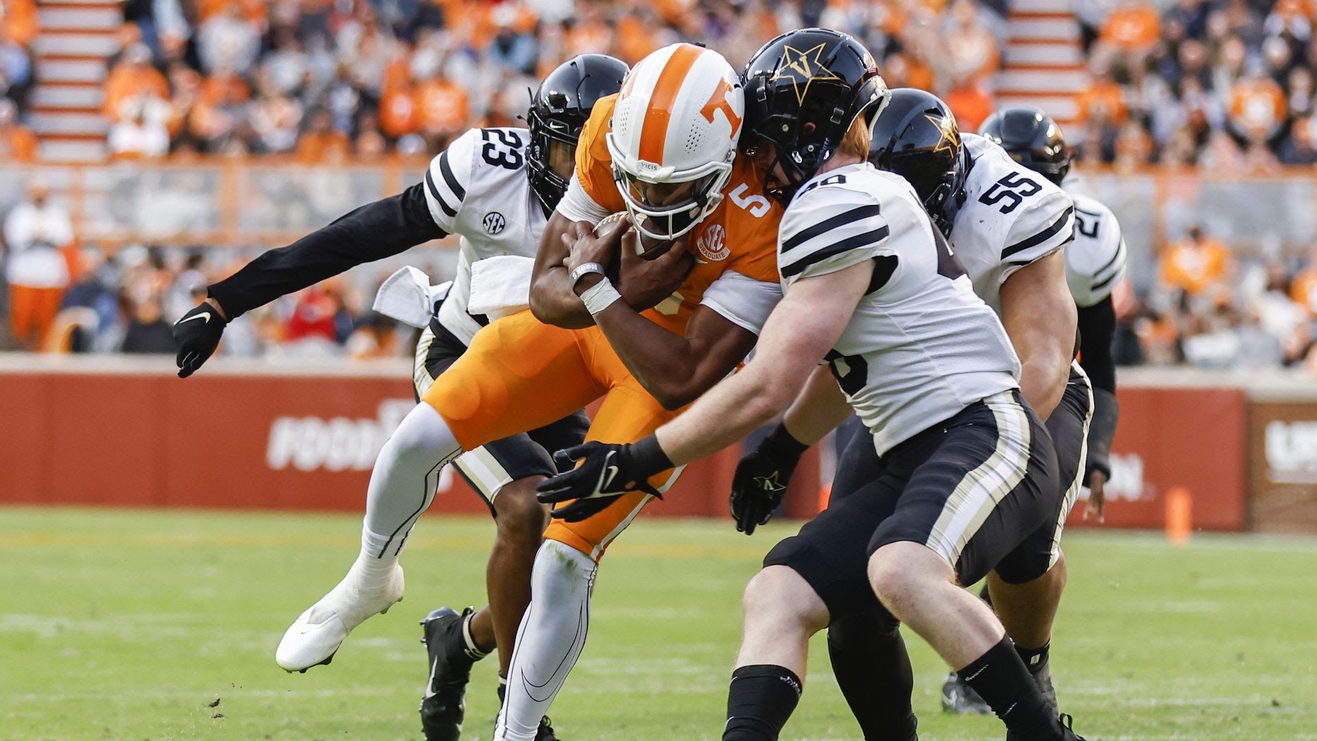 Tennessee quarterback Hendon Hooker is hit by Vanderbilt players in November. 