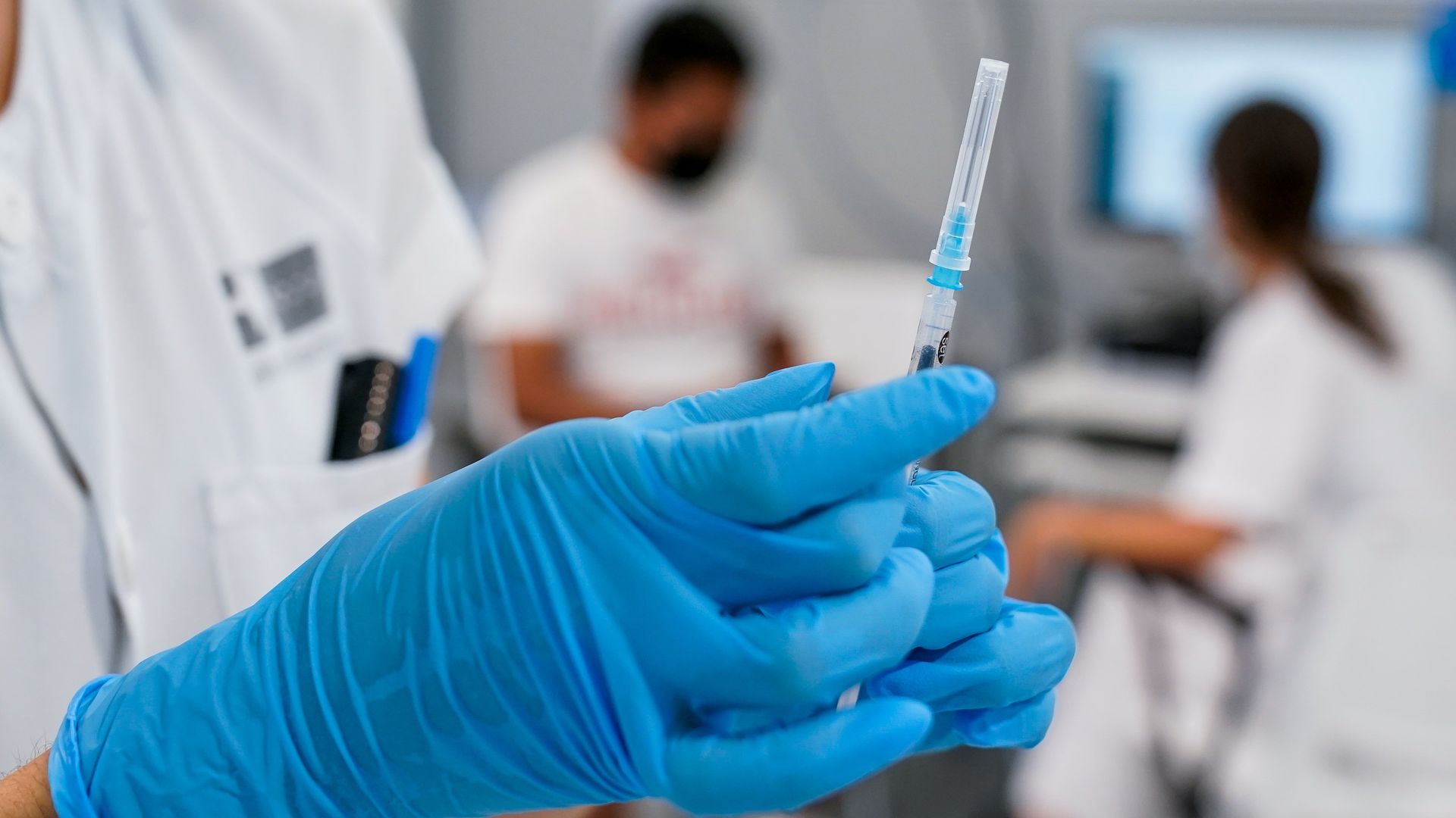 Nurse prepares to administer vaccine.