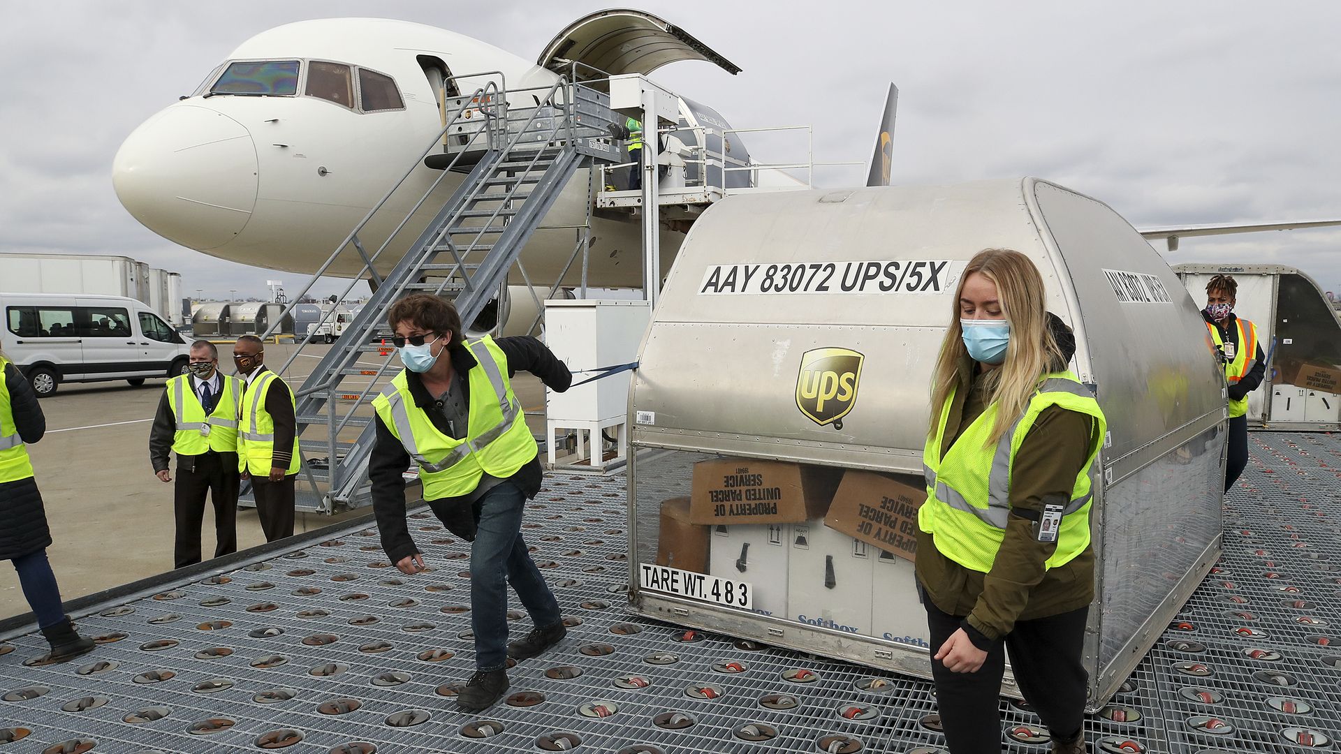 Workers move a large package of coronavirus vaccines 