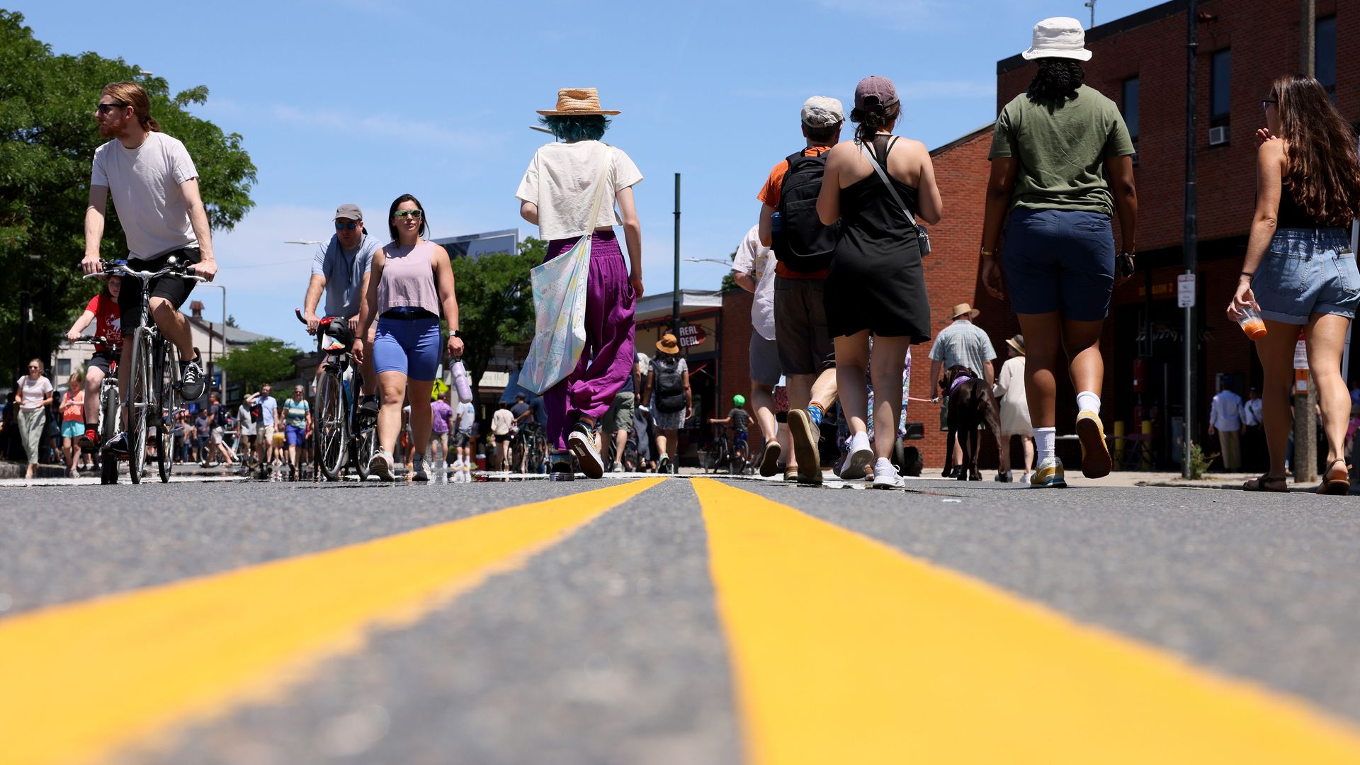 Pedestrians walk over the center line of a street