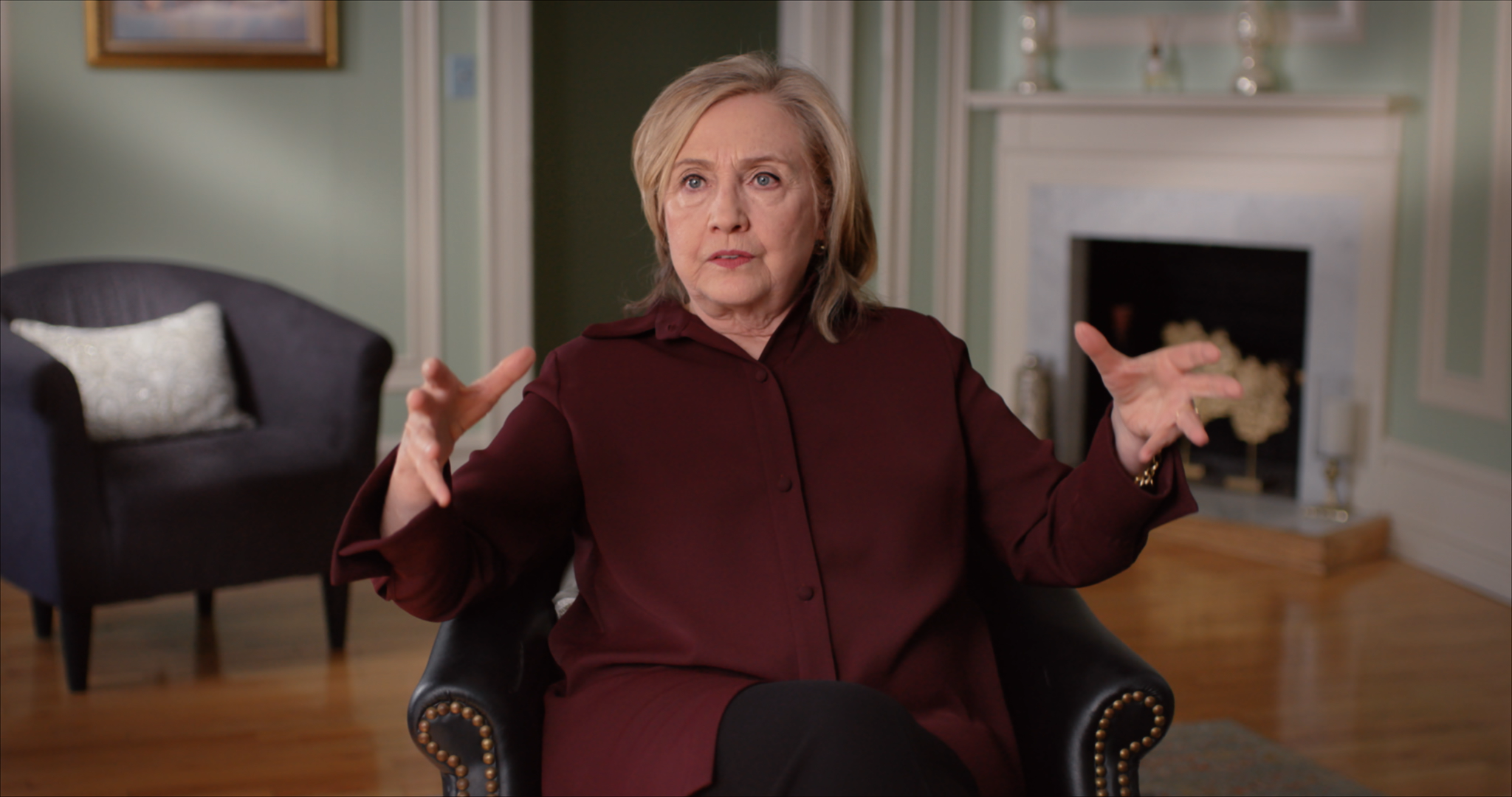 woman with hands in the air on a chair 