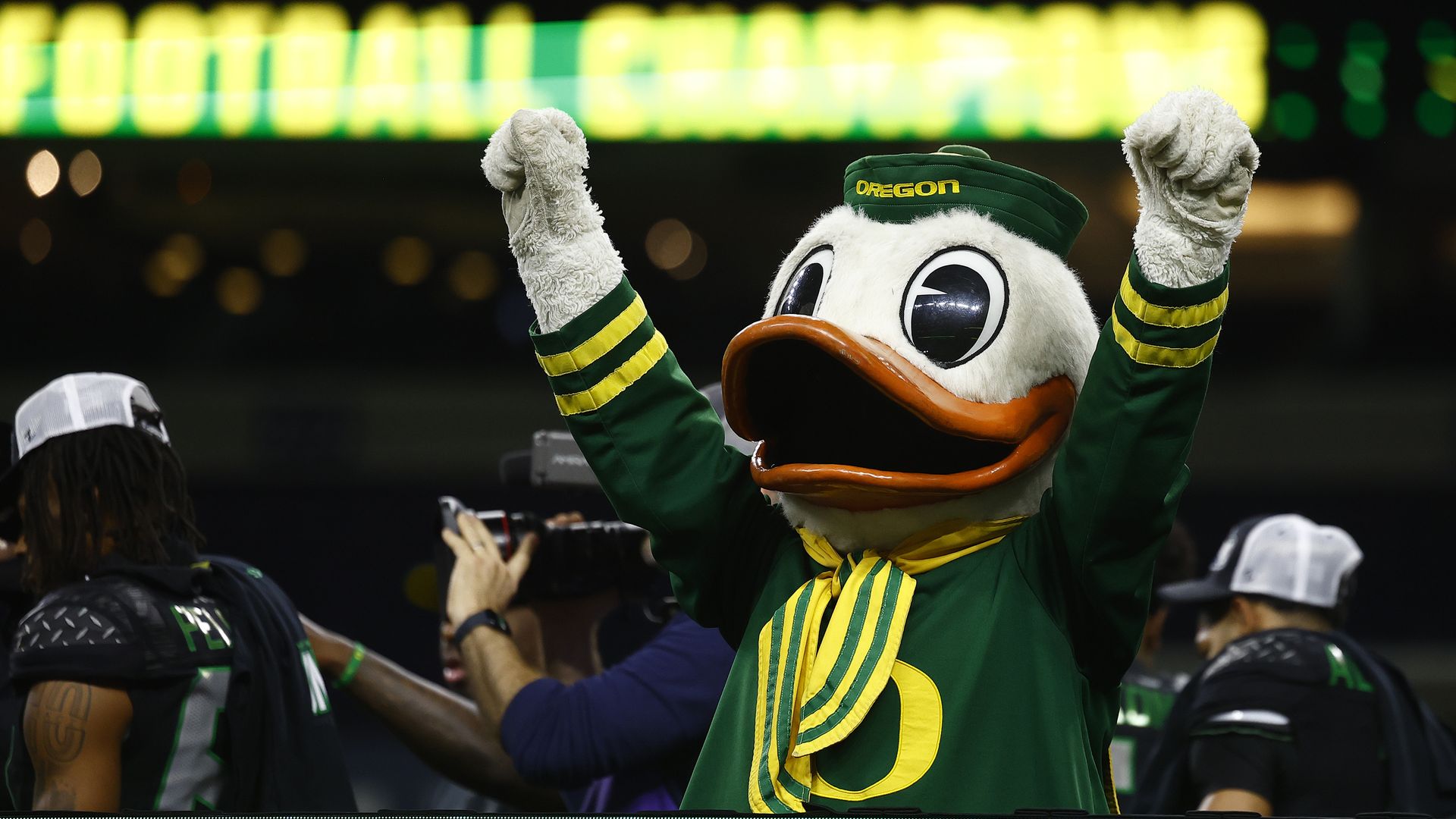 The Oregon Ducks mascot raises his arms in celebration after the team won the Big Ten championship.