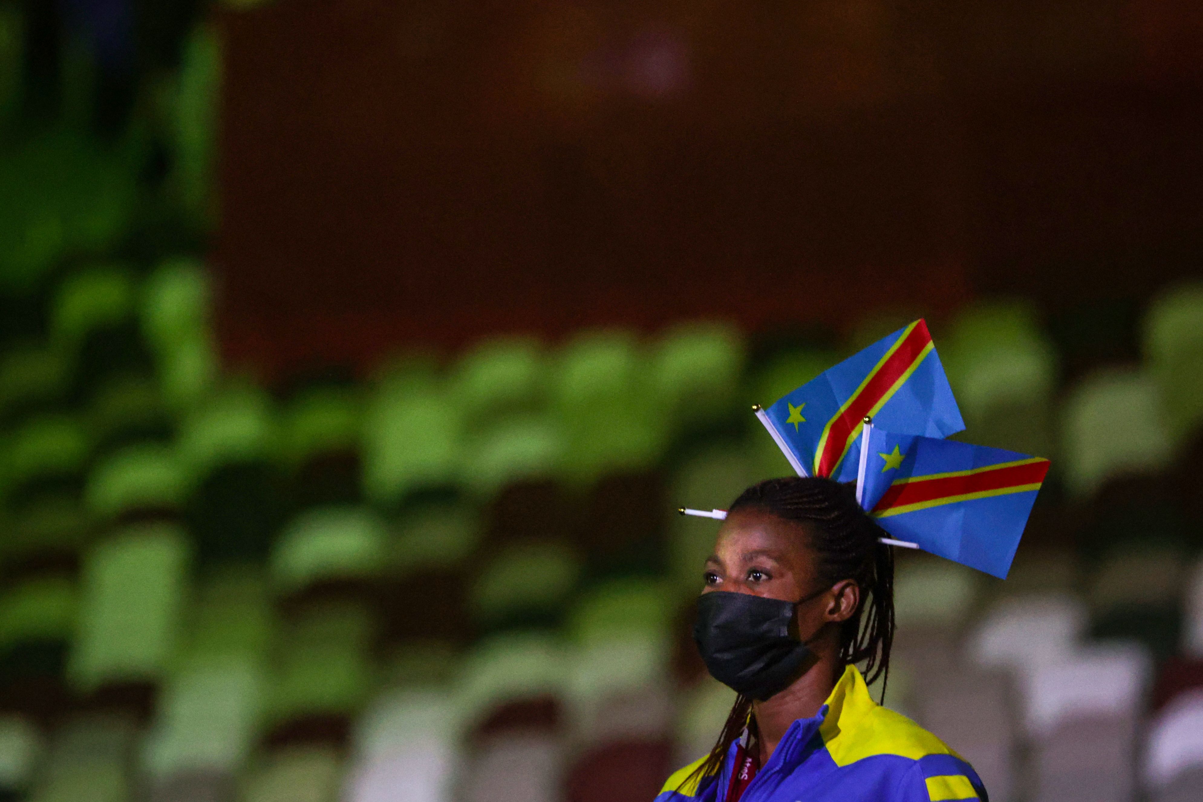 Picture of a Congo athlete at the opening ceremony, they're wearing two Congo flags on their head