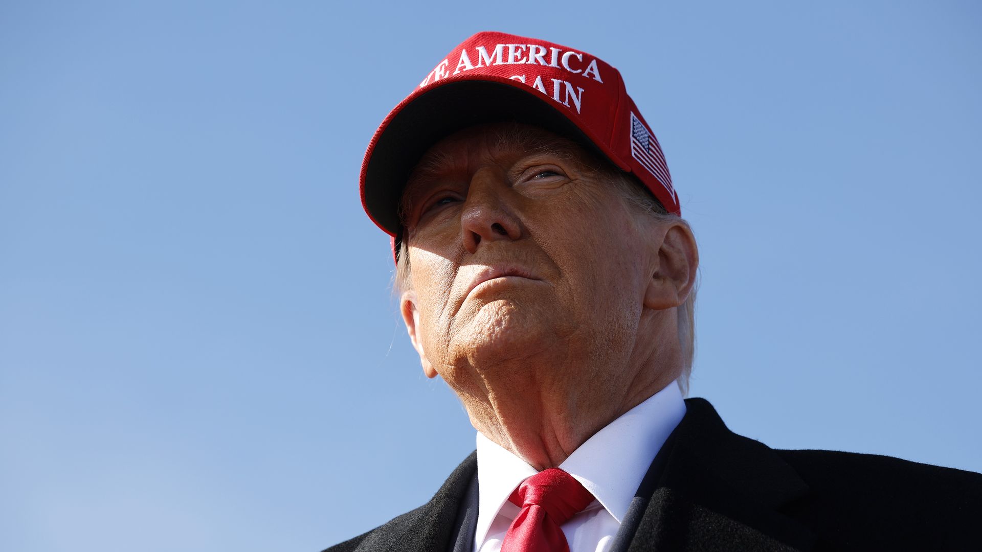 Former President Trump wearing a Make America Great Again hat.