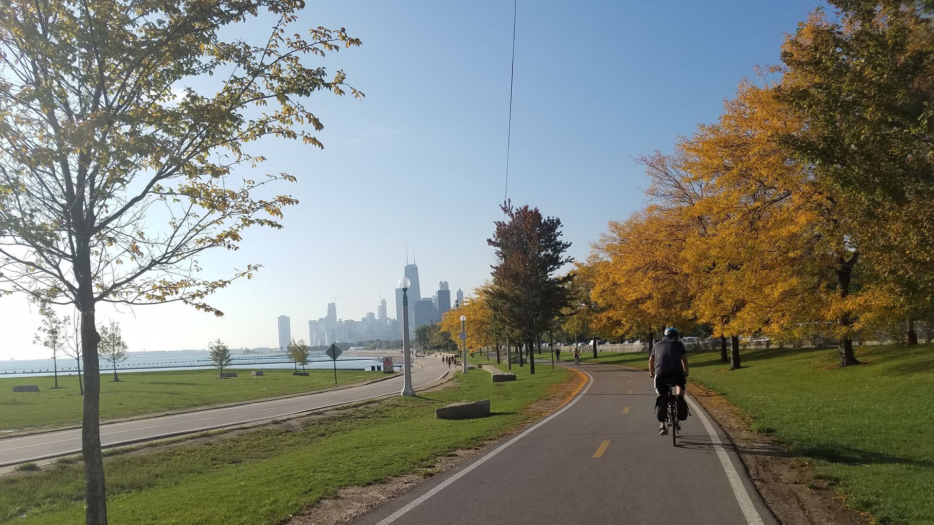 A photo of the bike path along a lake. 