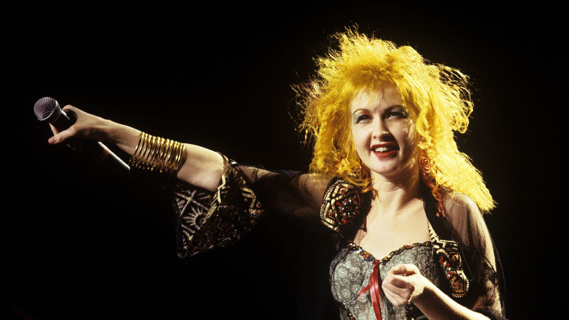 Cyndi Lauper performs on stage in the 1980s. 