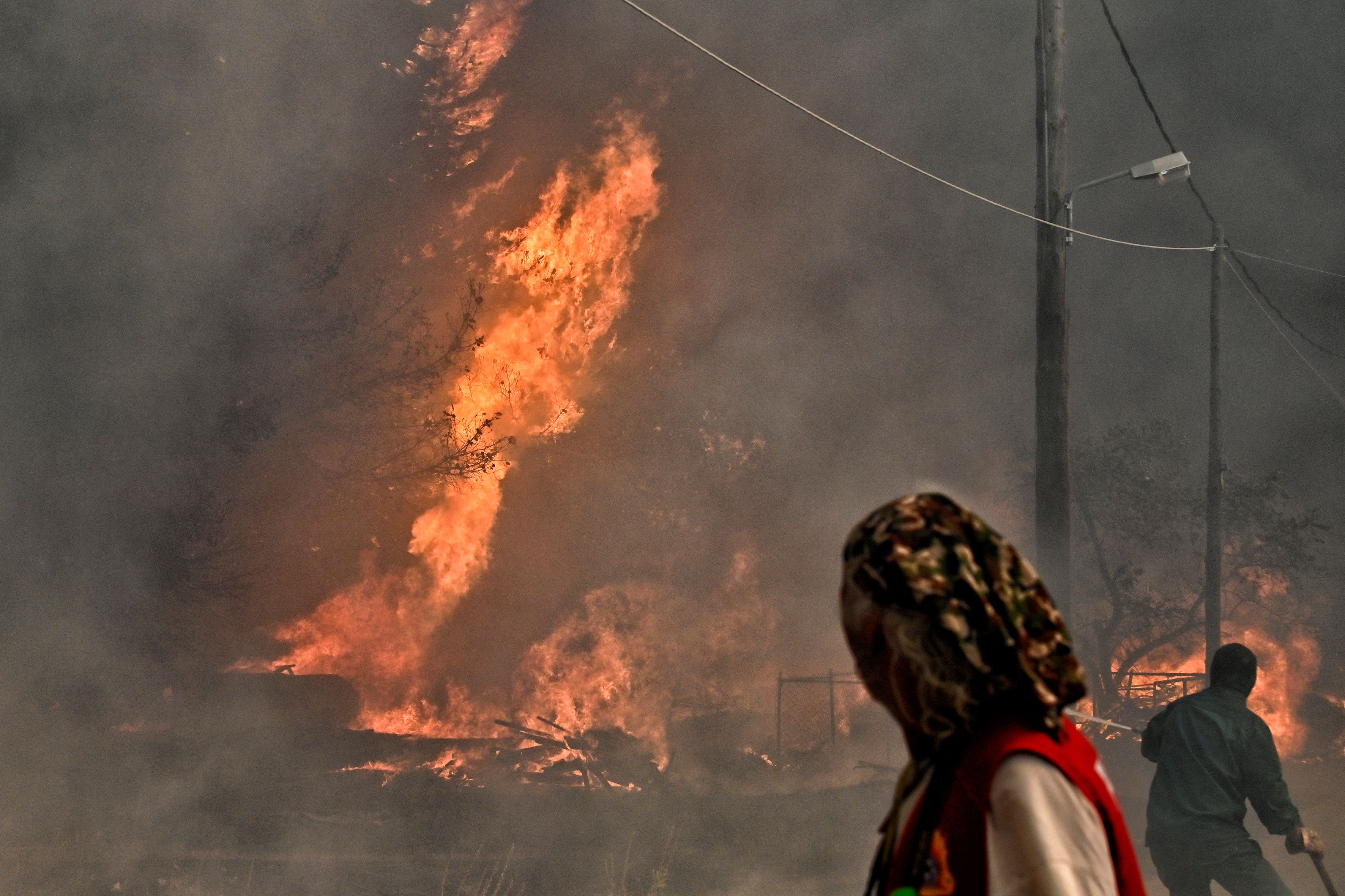 A wildfire near the resort town of Loutraki, east of Athens on July 17. The heat wave forced the temporary closure of the Acropolis monument in Greece's capital last week. 