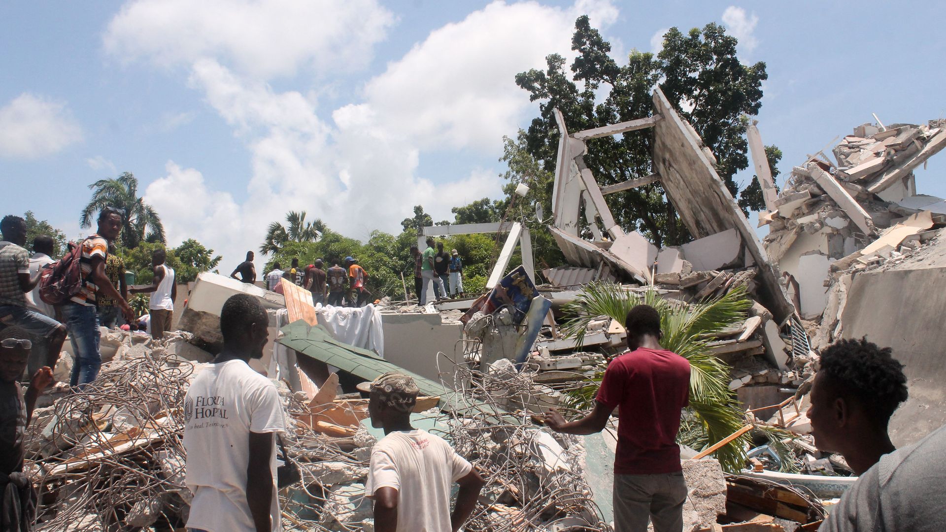 People search through the rubble of what used to be the Manguier Hotel after the earthquake hit on August 14