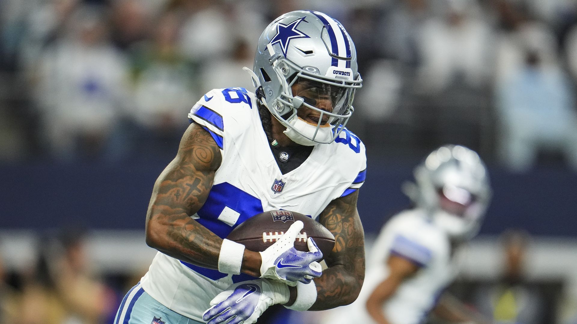 A football player holds the ball during a game