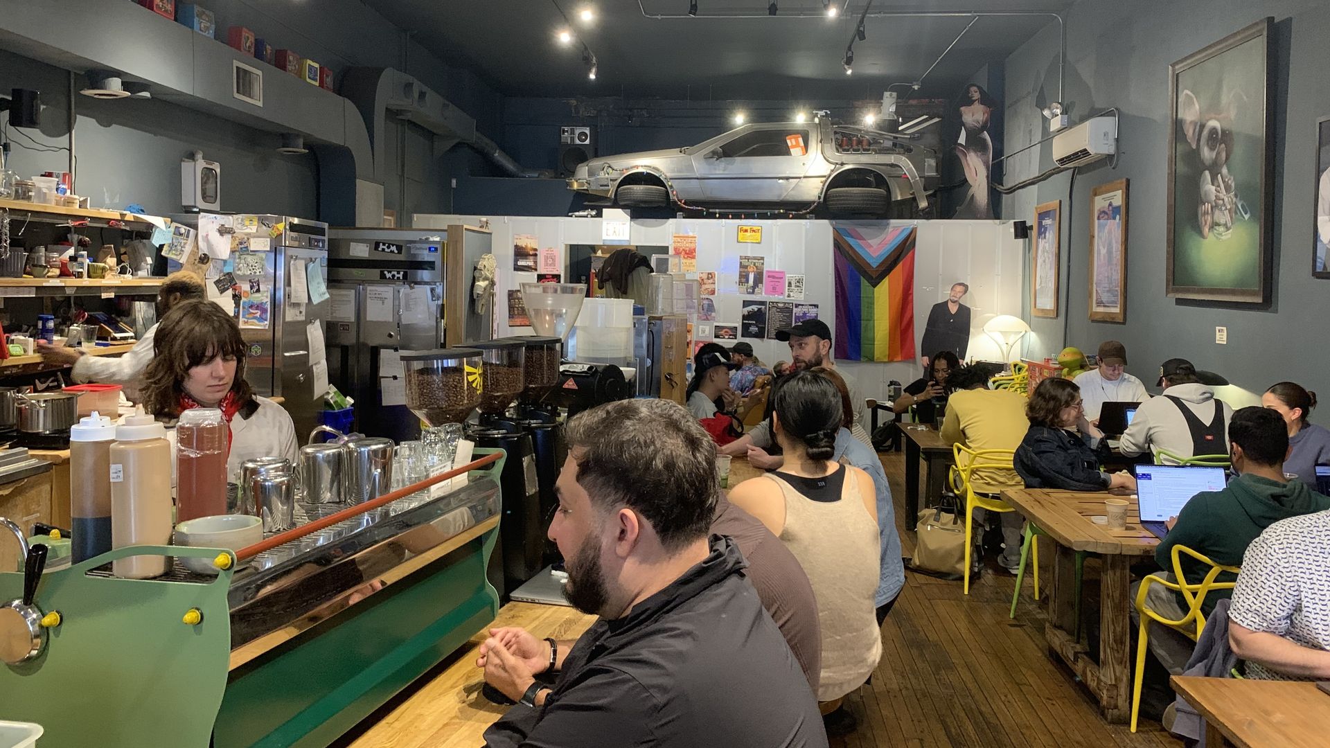 Photo of a coffee shop with pop culture decor including a replica of a car.