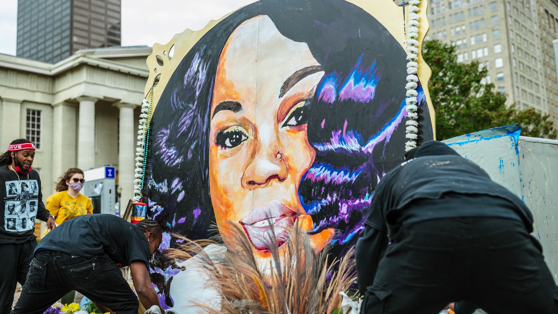 People maintaining the decorations around a memorial for Breonna Taylor in Louisville in September 2020.