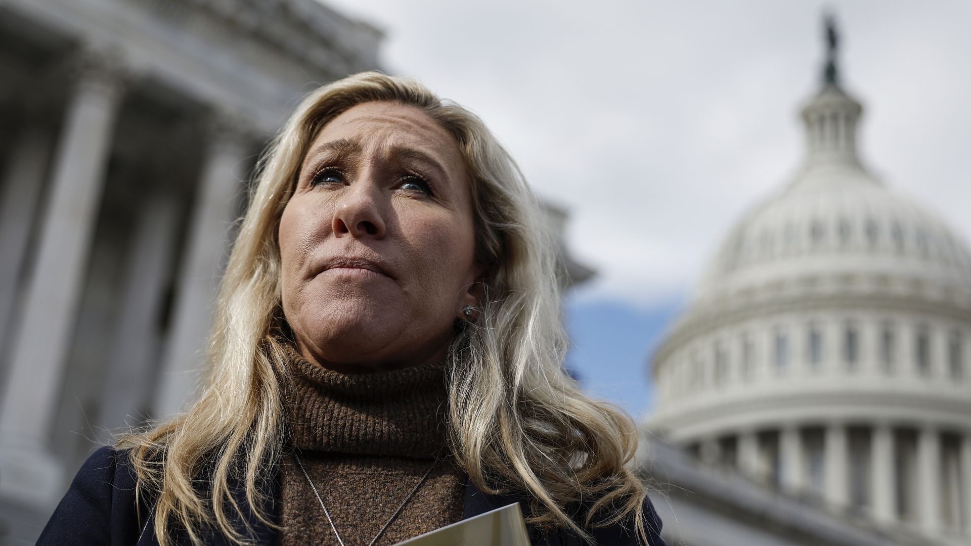 Rep. Marjorie Taylor Greene looks off into the distance.