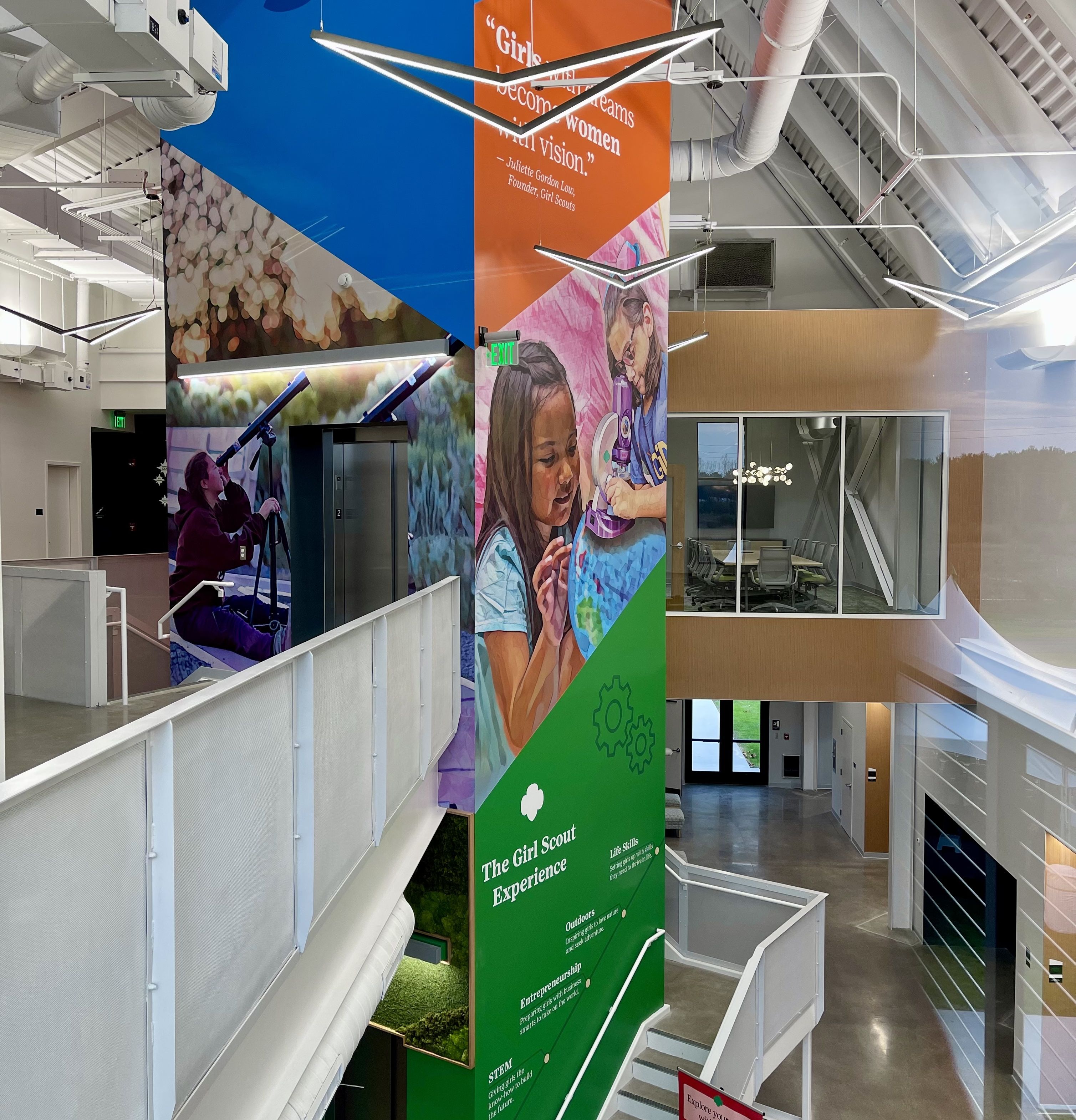 An overview of a mural in the lobby of the STEM Center, featuring a quote that says "girls with dreams become women with vision"