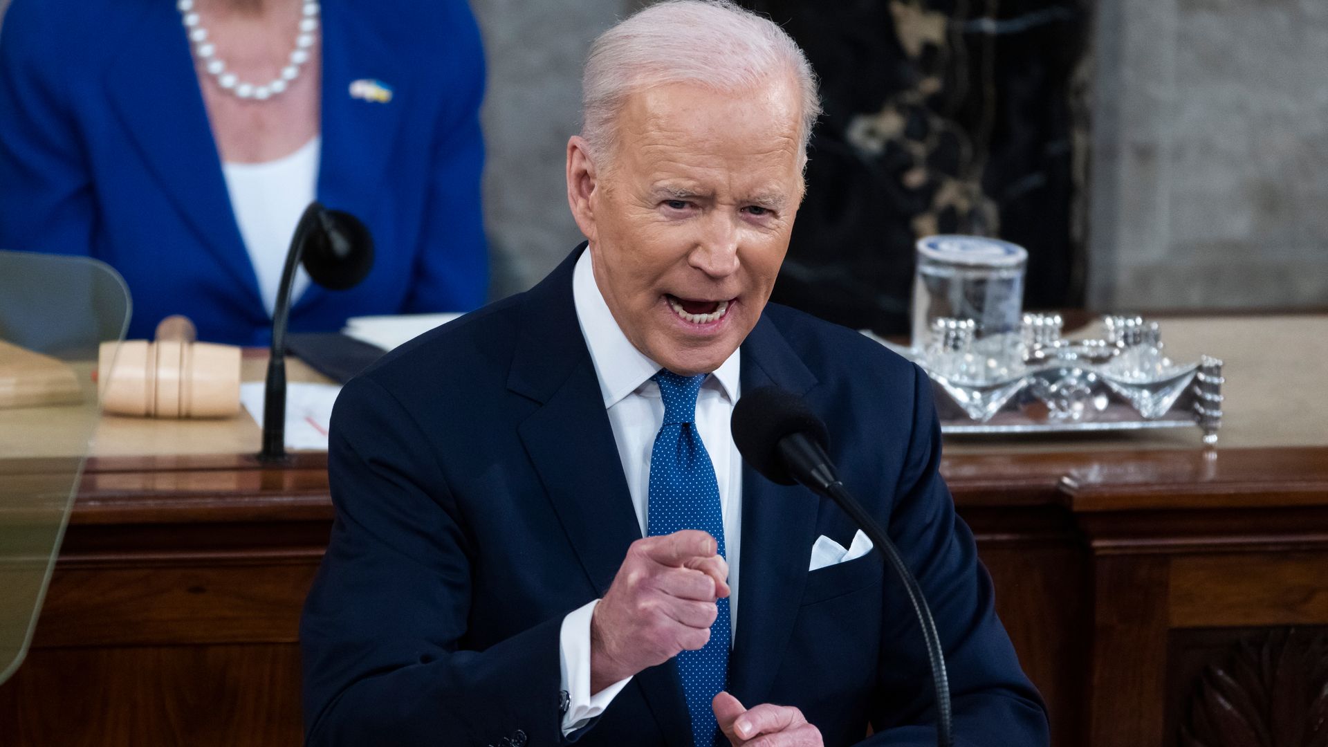 Photo of President Biden at the lectern pointing his finger