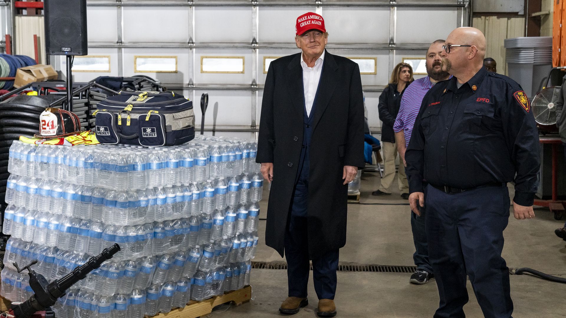 Trump with racks of bottles of water