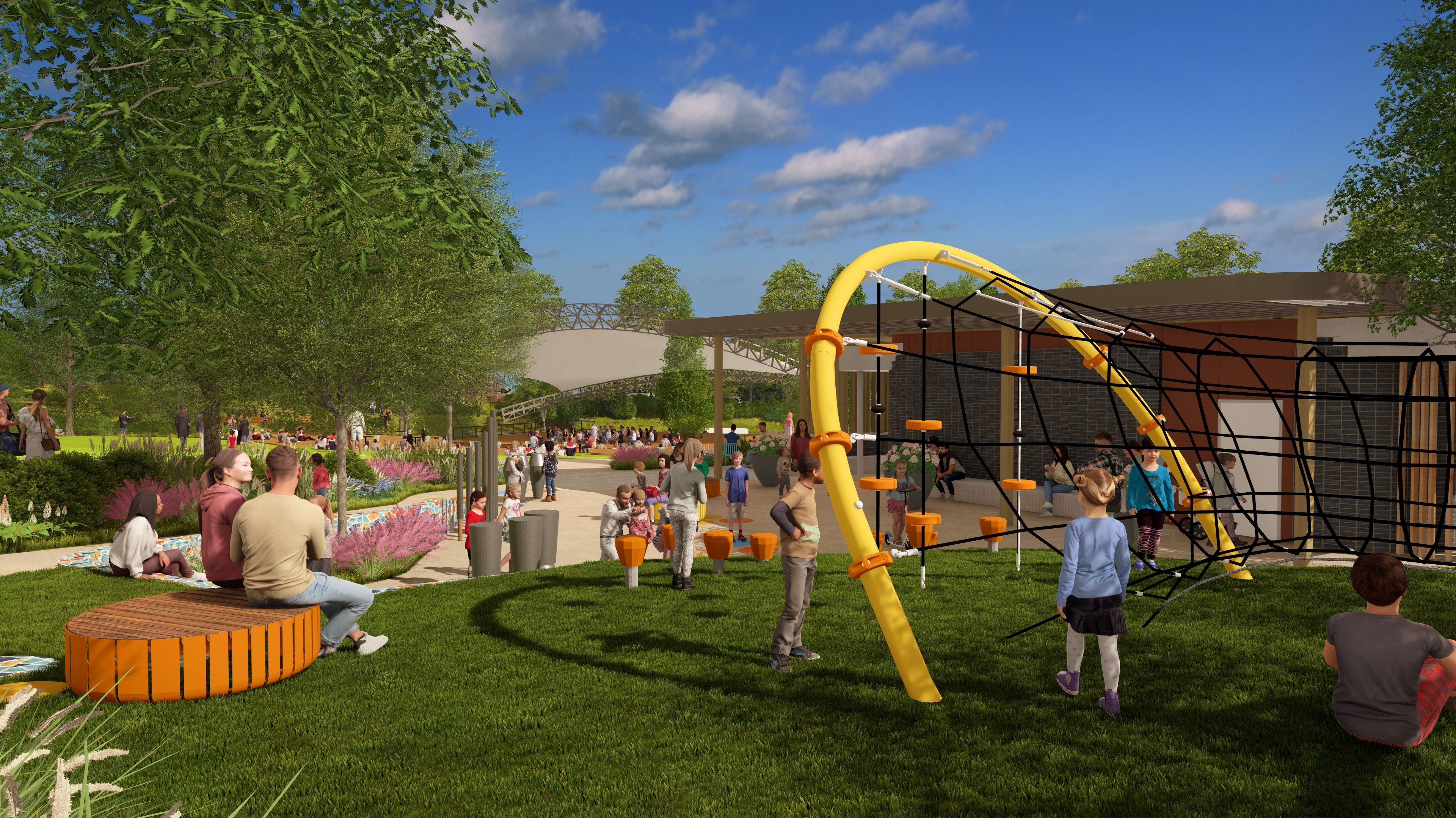 Sunny park with a modern playground: yellow curved climbing arch, black net, orange steps; kids play while adults watch near a brick building, green grass, trees, and blue sky.