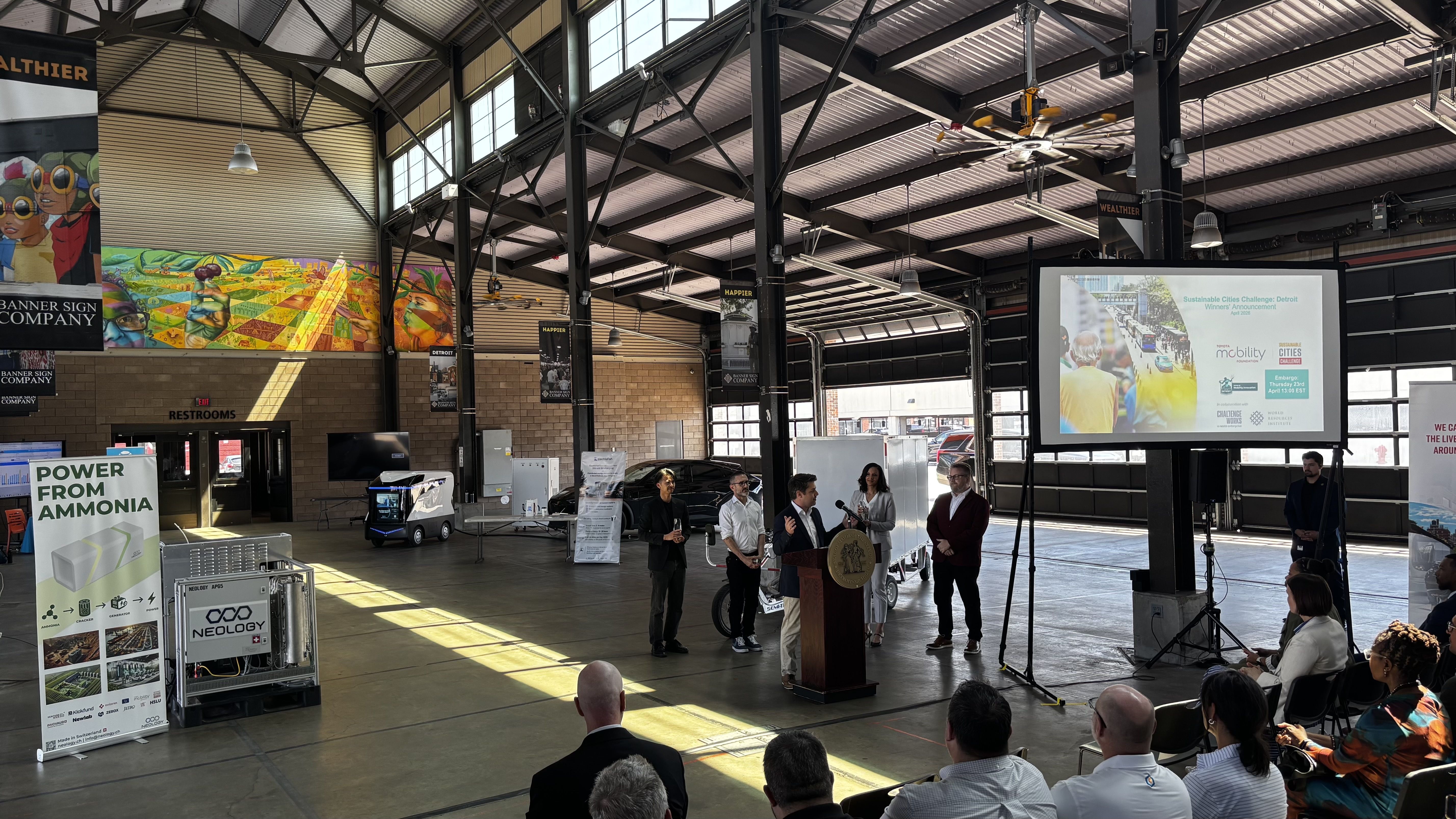 Neology CEO Aris Maroonian, at the podium, at Thursday's event. 