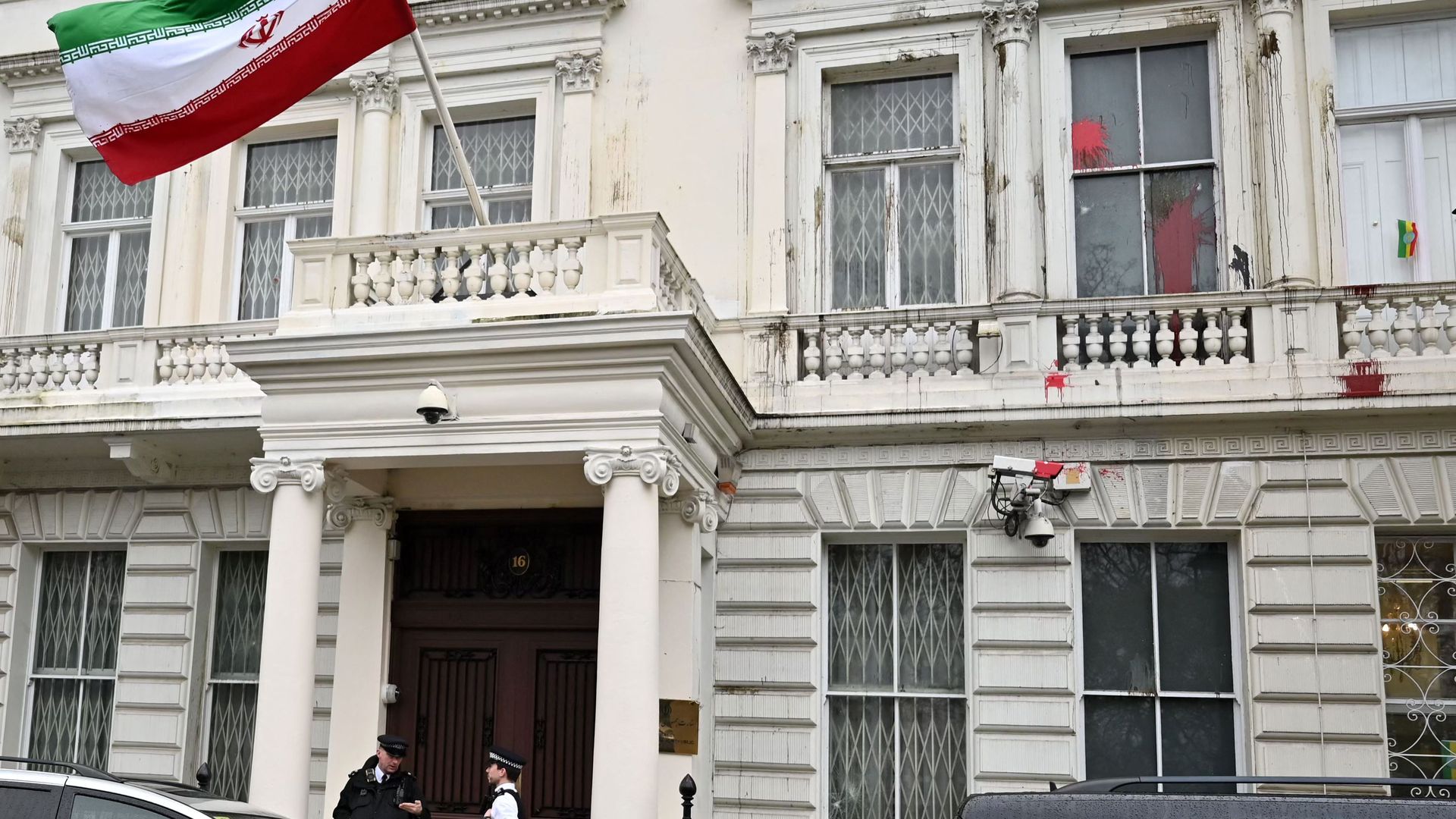 Security guards stand outside Iranian Embassy in London.