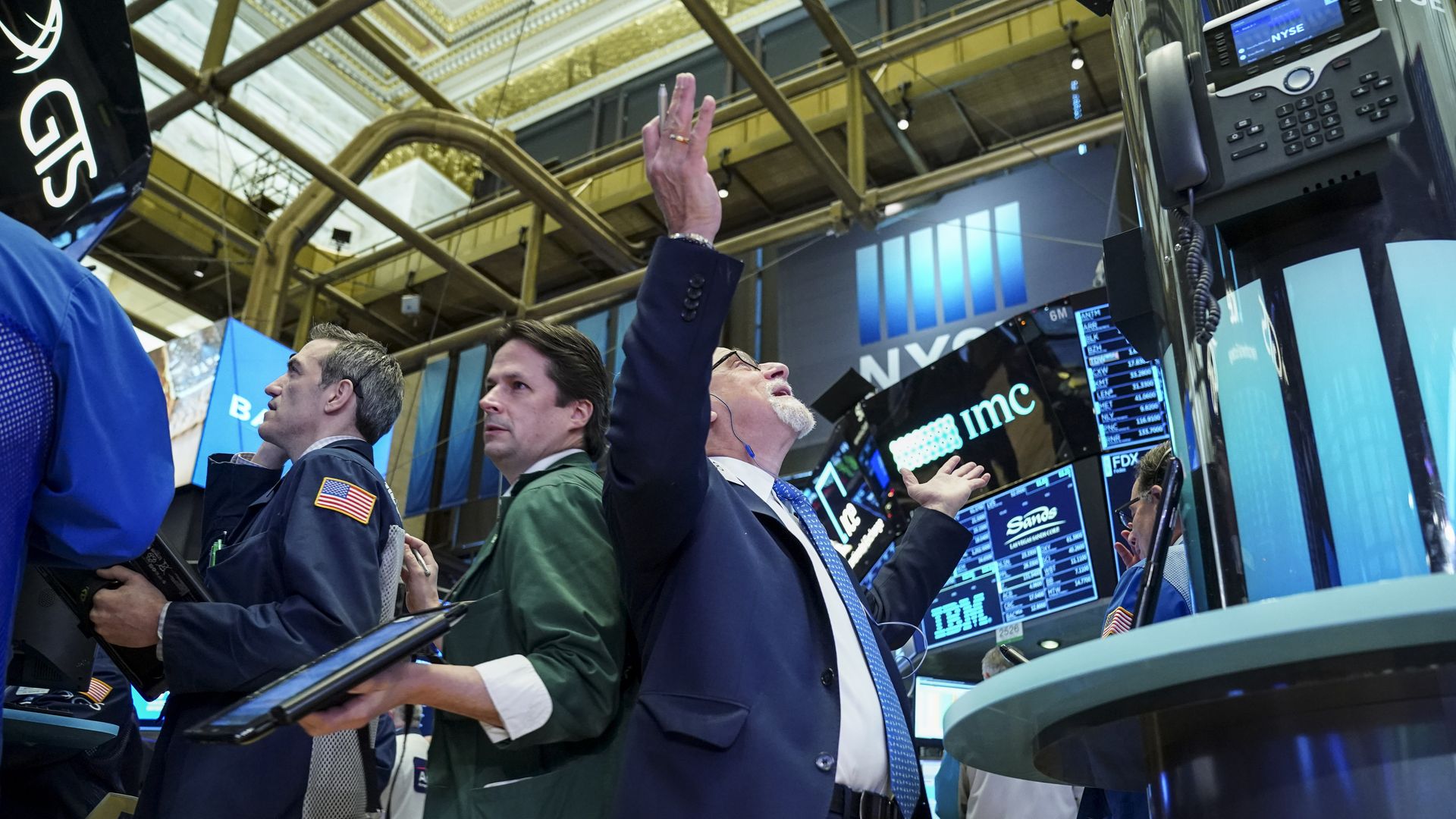 Trader throws arms up on the New York Stock Exchange floor