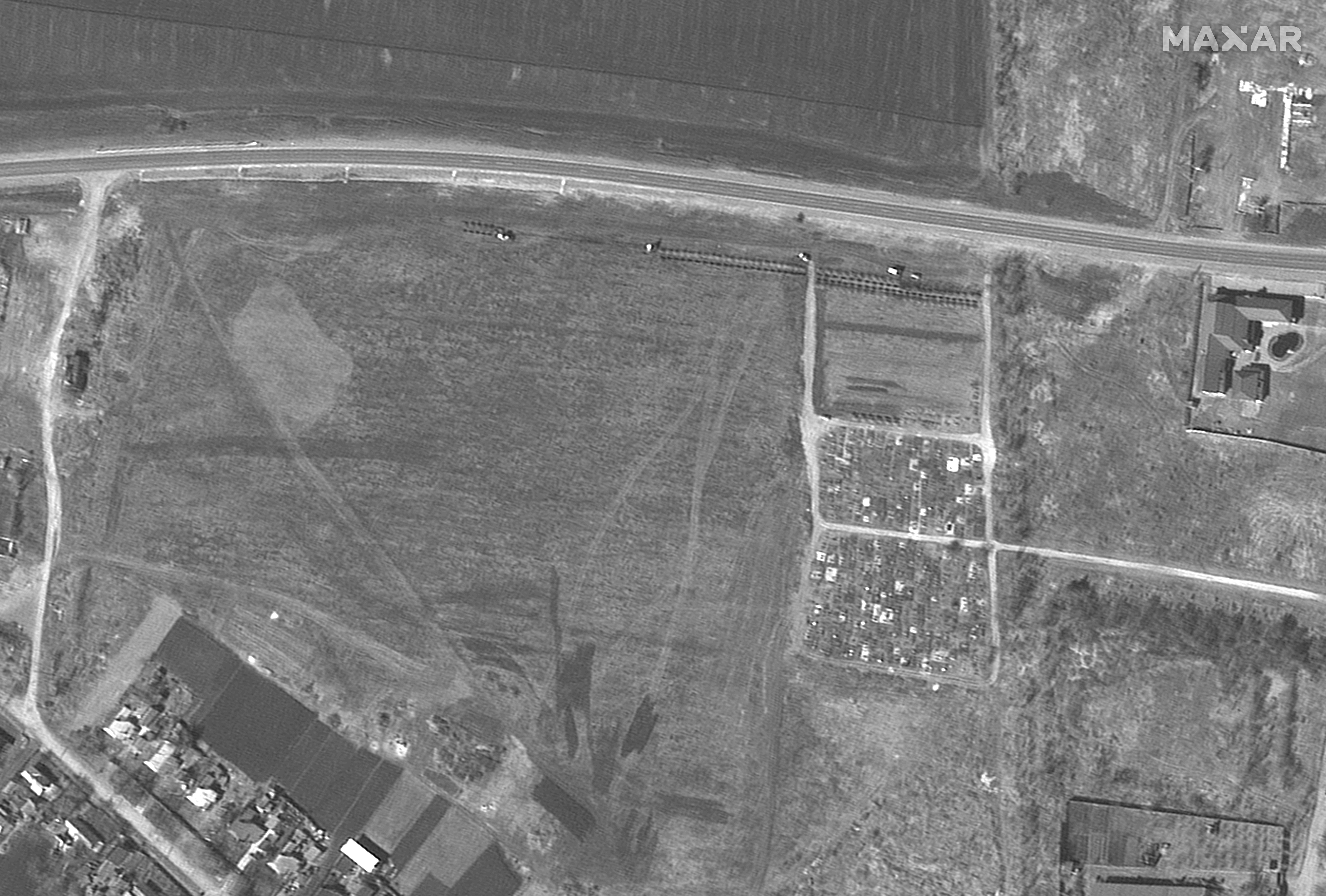 Another satellite image captured on March 26 showing the cemetery with a line of newly dug graves.