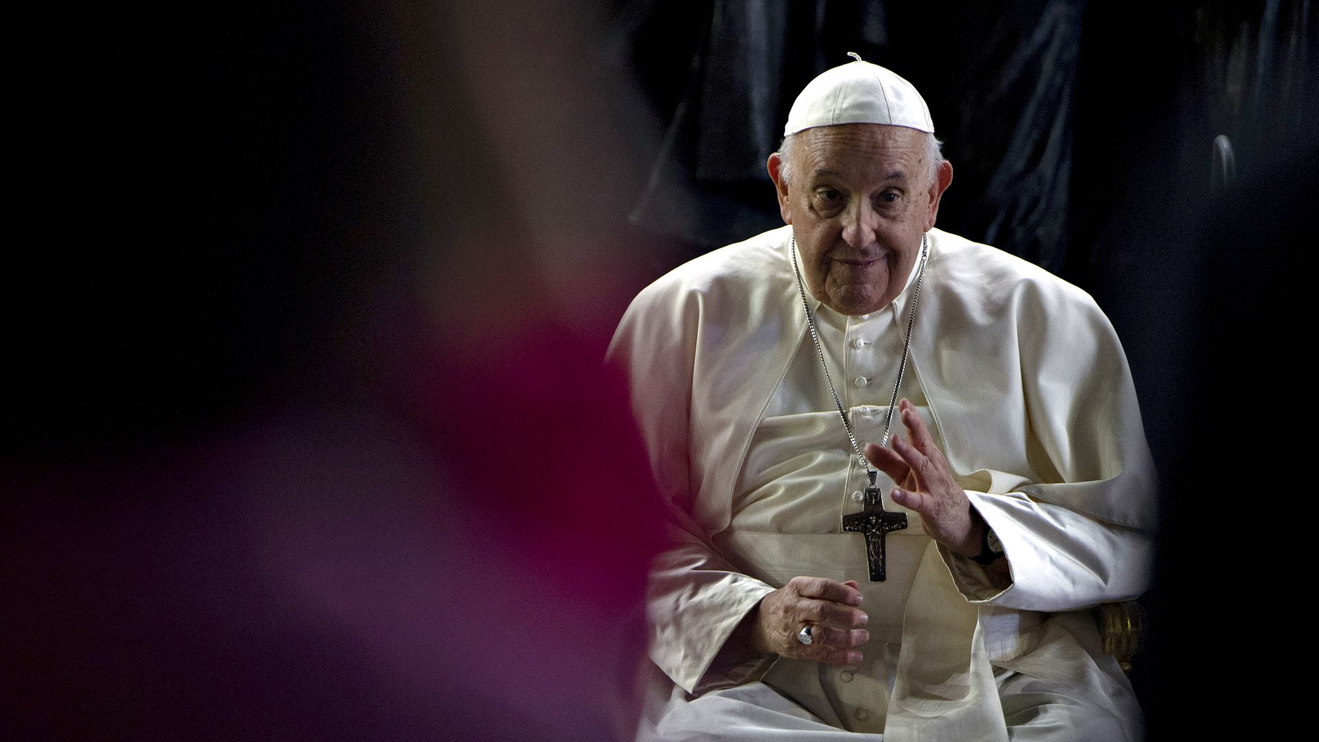 The pope issuing a blessing. 