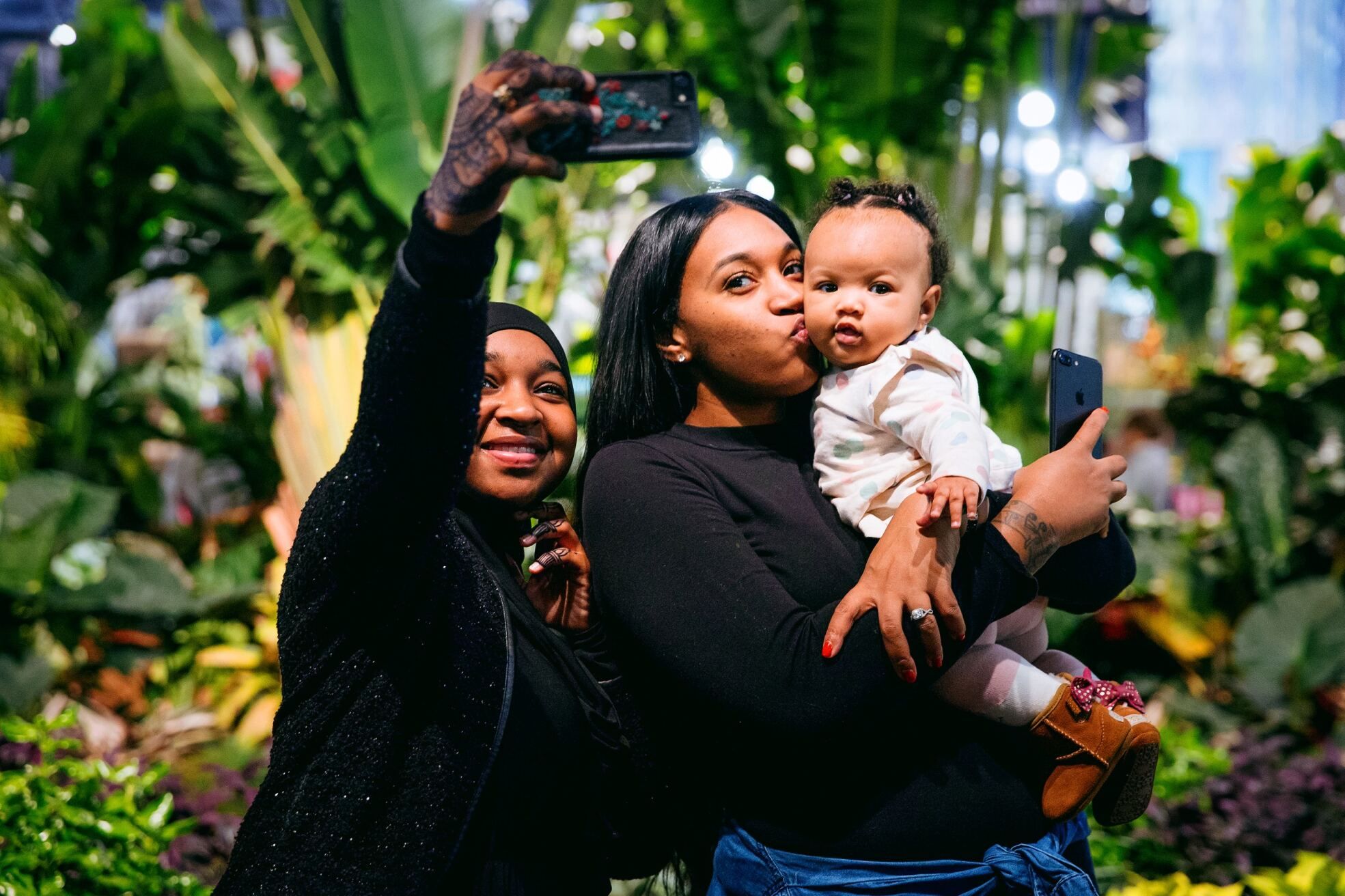 A family takes a selfie at the Flower Show.
