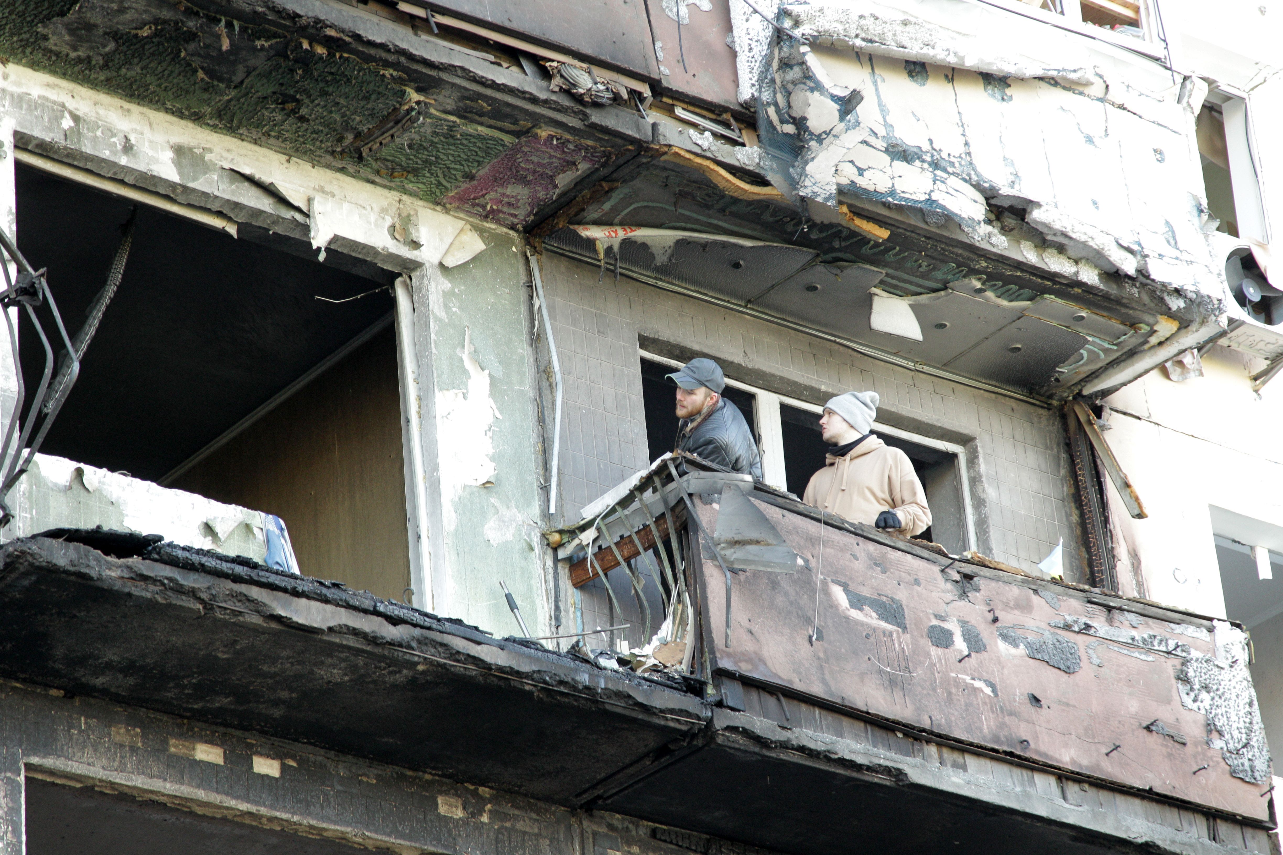 Residents on a balcony in an apartment building hit by a shell from the Russian army in one of the dormitory districts of Kyiv, capital of Ukraine, on March 14.