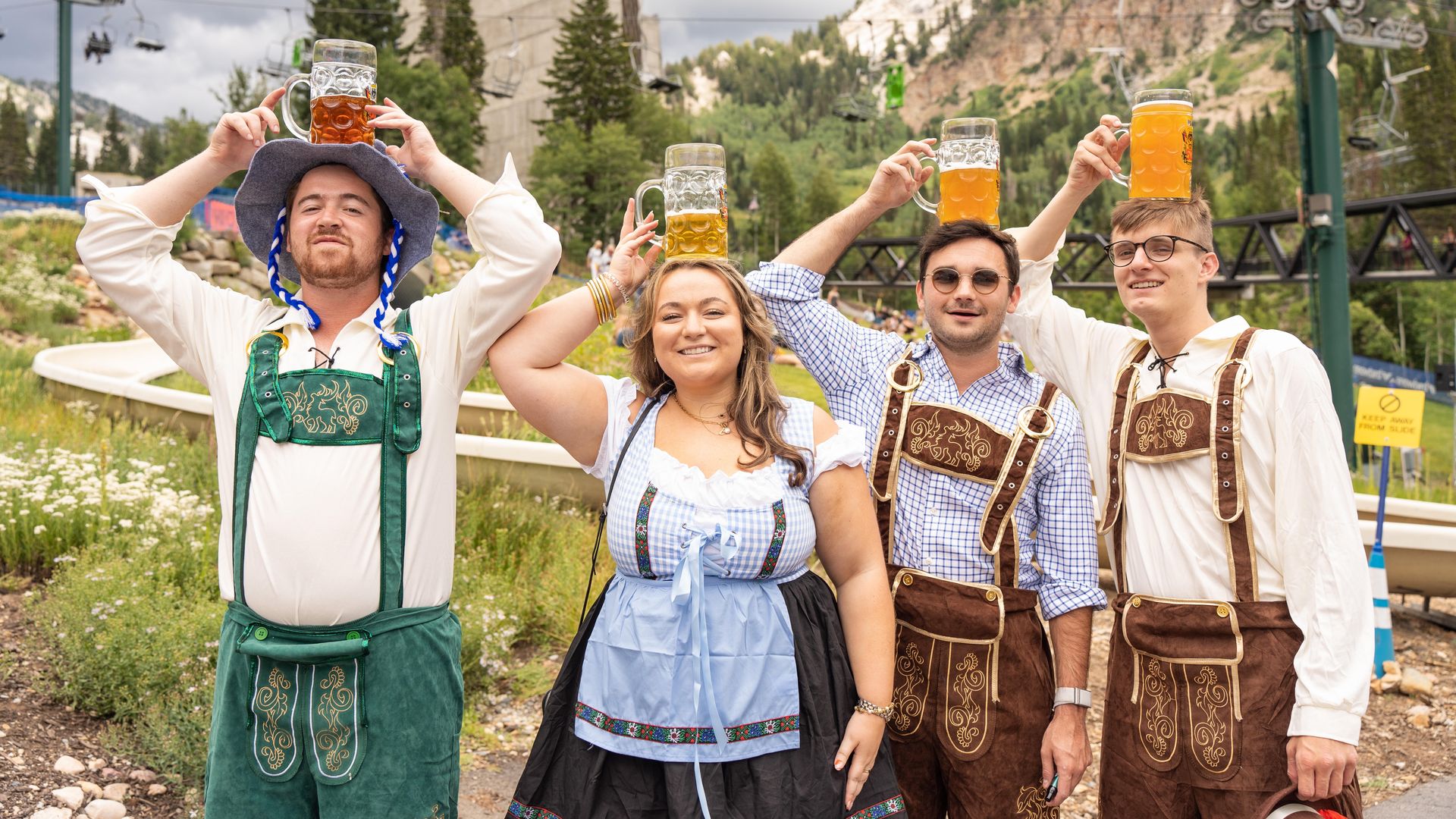 People holding beers over their heads during Oktoberfest.