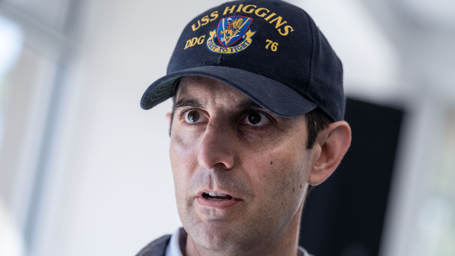 Rep. Chris Deluzio in 2024 wearing a navy blue hat that reads USS Higgins