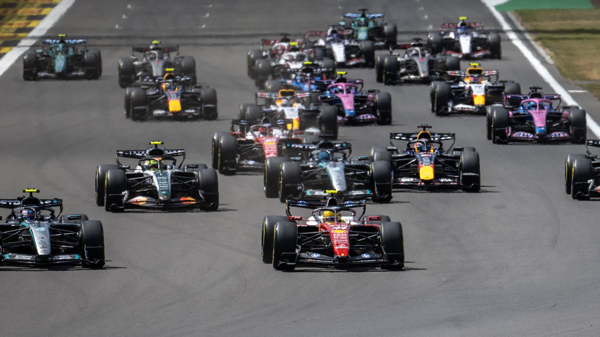 Ferrari's British driver Lewis Hamilton and Mercedes' Italian driver Kimi Antonelli lead into the first corner during the sprint race ahead of the Formula One British Grand Prix at the Silverstone motor racing circuit in Silverstone, central England.
