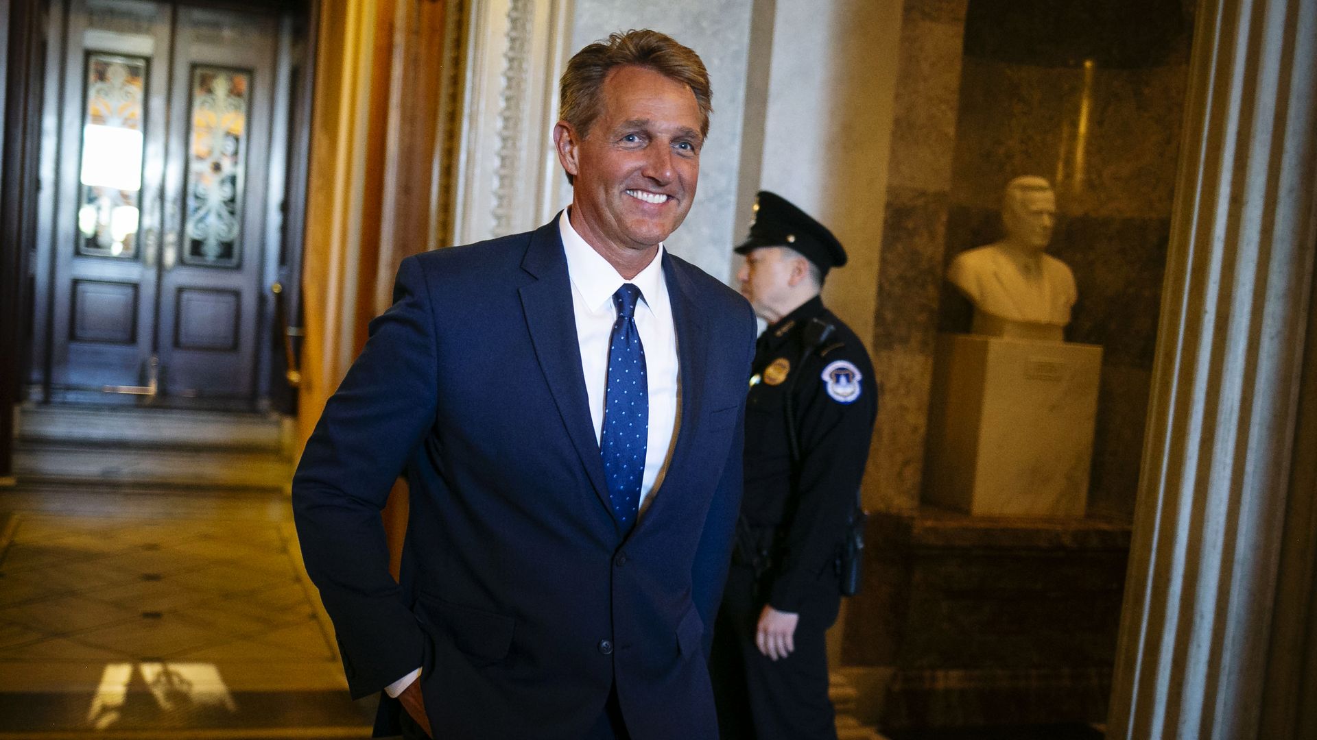 Former Sen. Jeff Flake is seen walking through the U.S. Capitol.