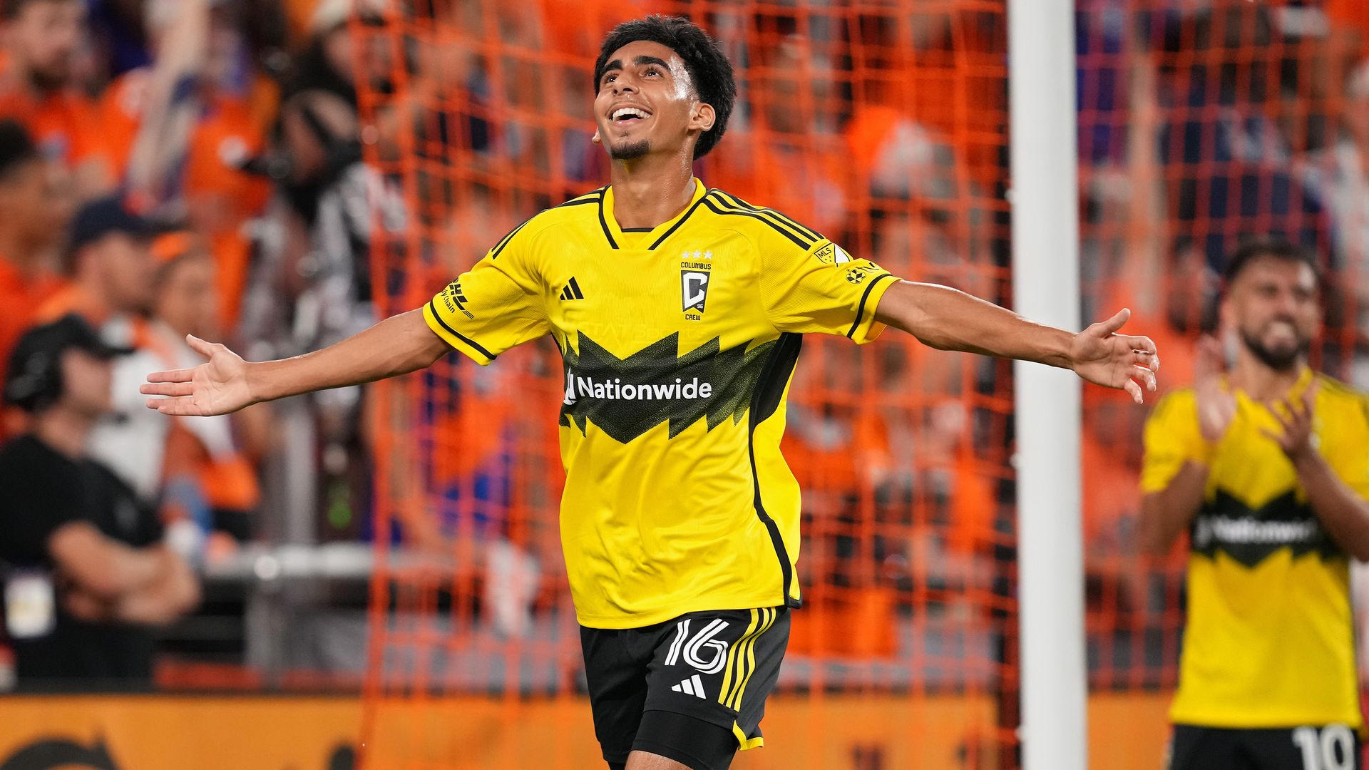 Columbus Crew midfielder Taha Habroune spreads his arms wide in celebration of a goal at FC Cincinnati