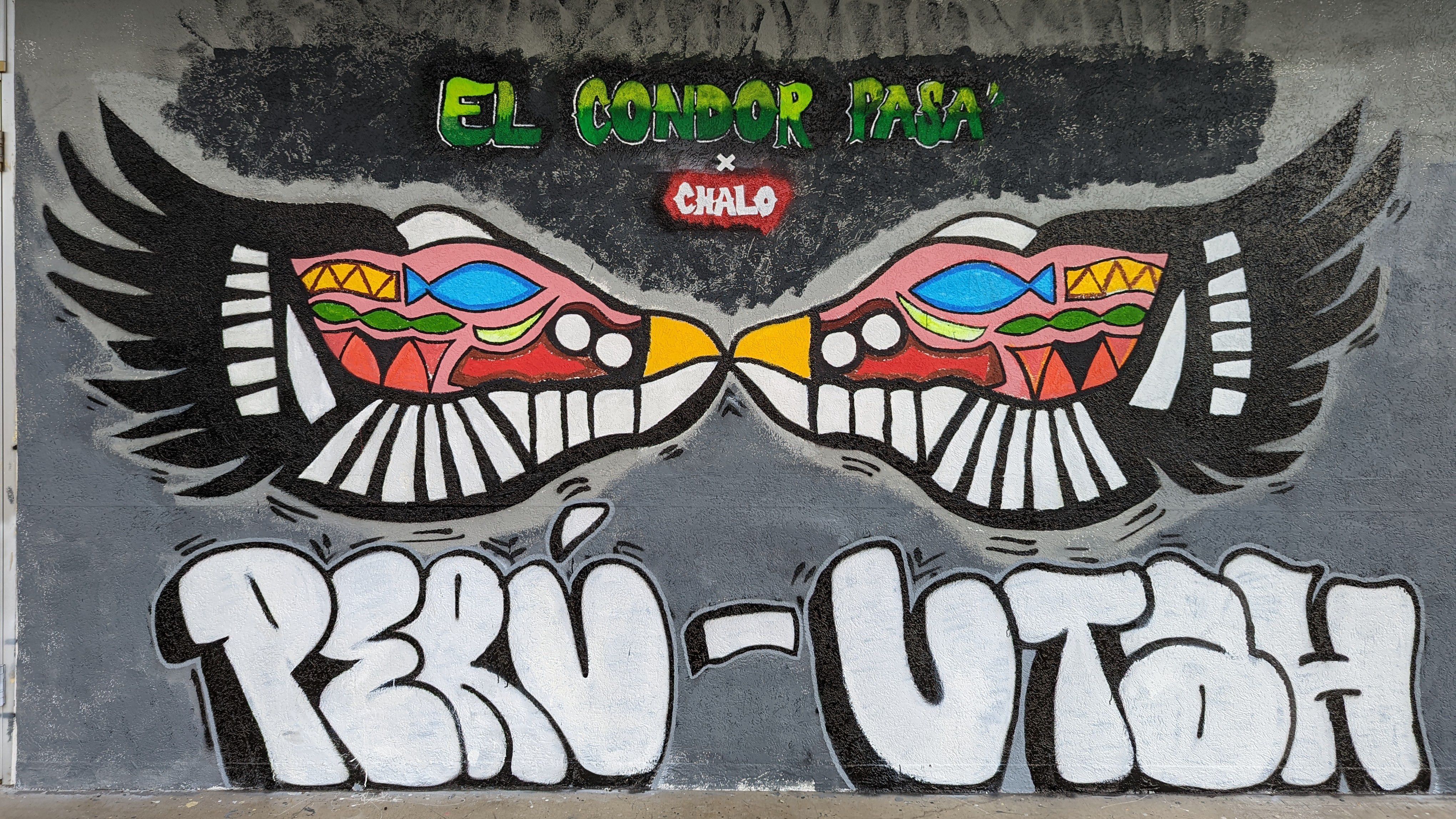 A mural shows two birds touching beaks with the words Peru-Utah