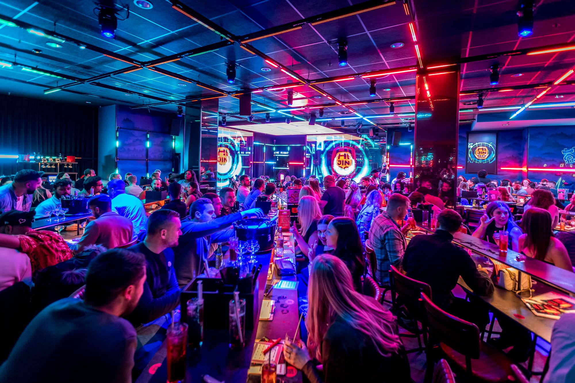 A nightclub interior filled with people playing bingo.