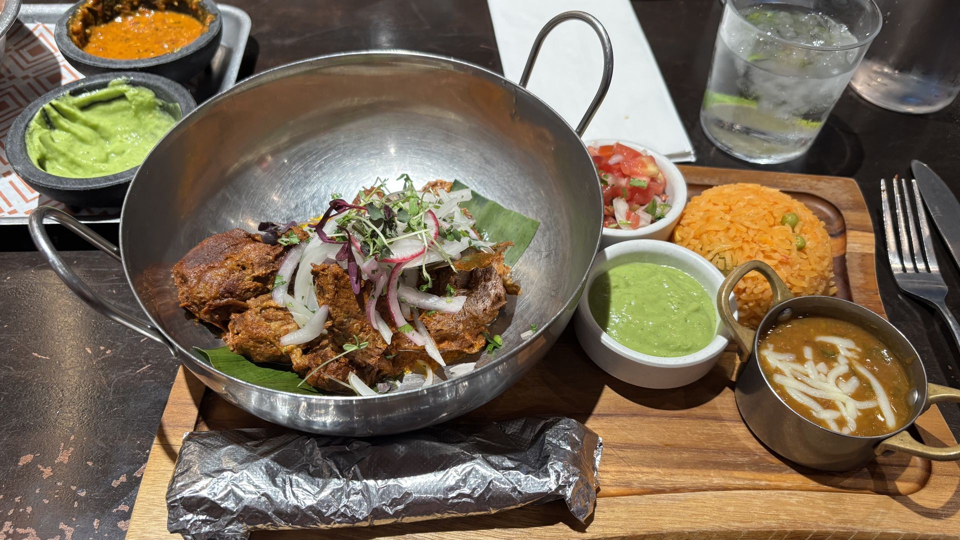 A fork-tender feast of roast pork, Spanish rice and charro beans. Photo: Ryan Deto/Axios