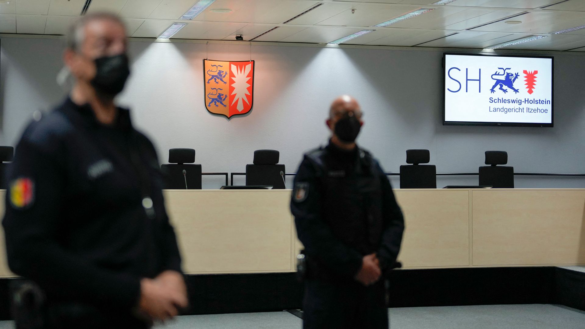 Judicial police officers standing in an empty room in Langericht Itzehoe court prior to the trial against the 96-year-old former secretary for the SS commander of the Stutthof concentration camp