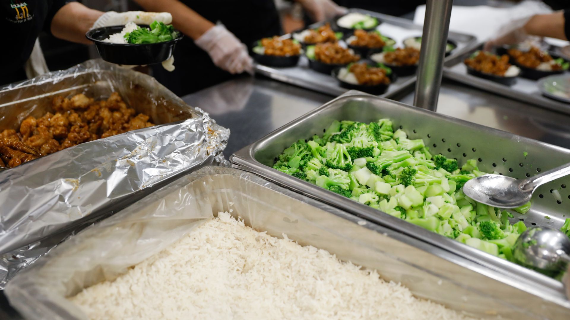 Cafe staff at John Liechty Middle School in Los Angeles prepare lunch on Wednesday, December 7, 2022