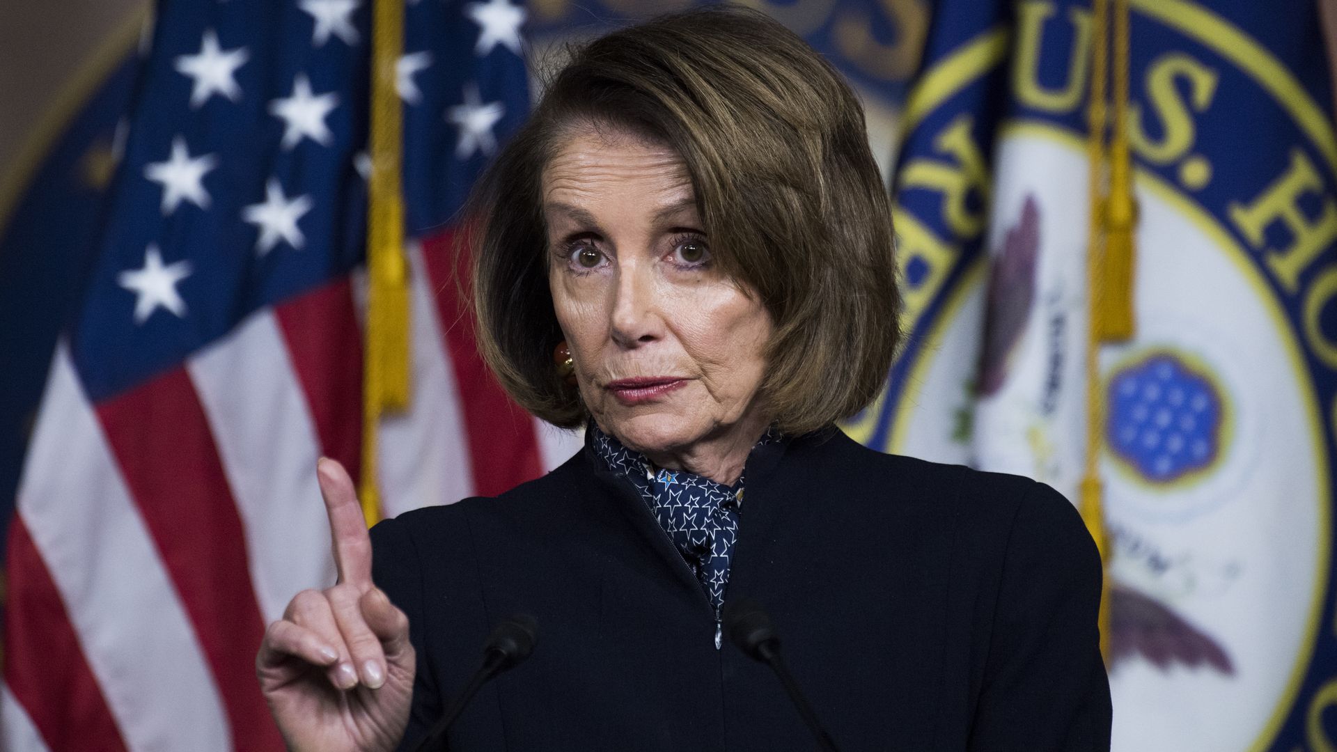 Nancy Pelosi with a finger up as she speaks