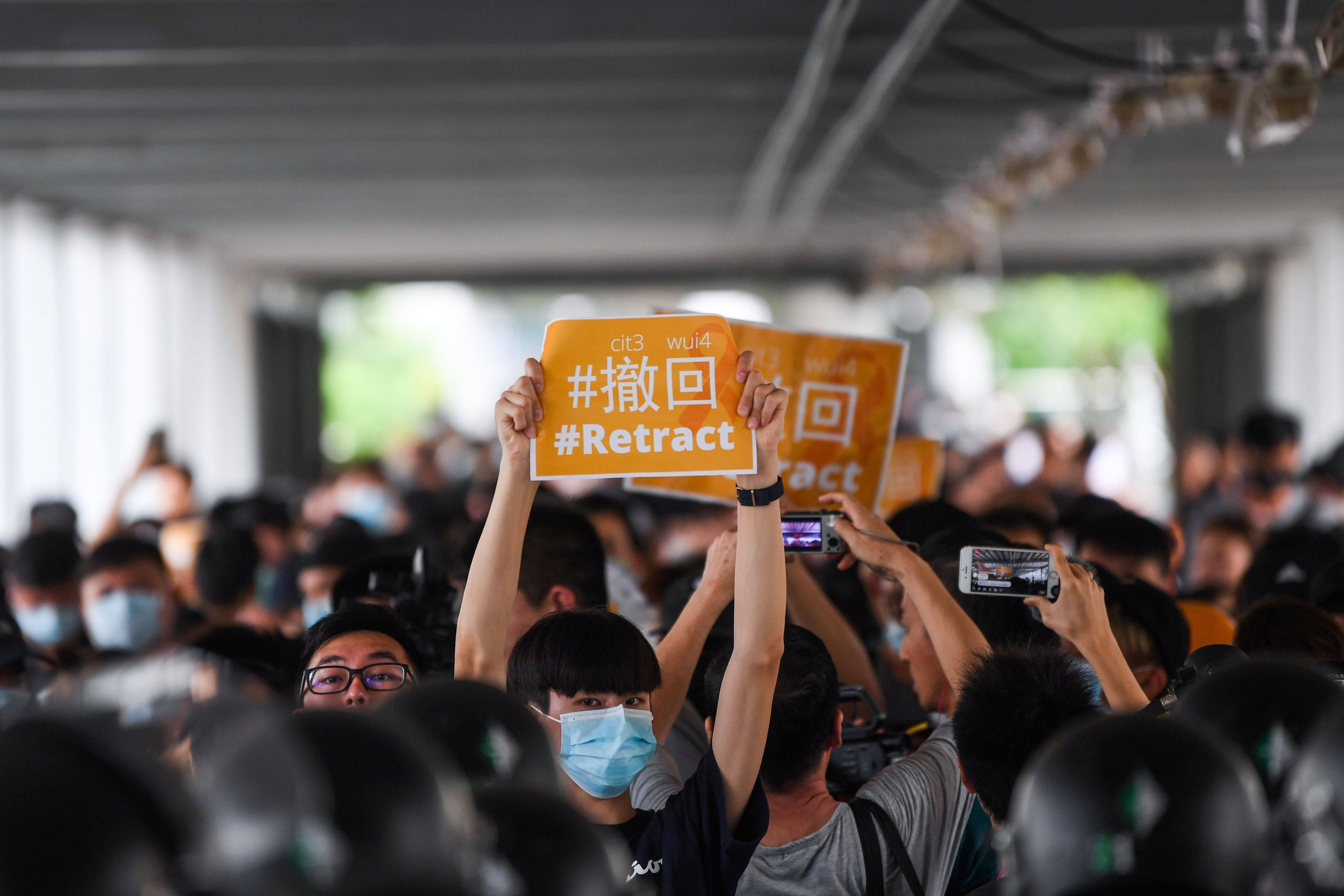Protesters display placards during a demonstration against a controversial extradition law proposal in Hong Kong on June 13, 2019. 