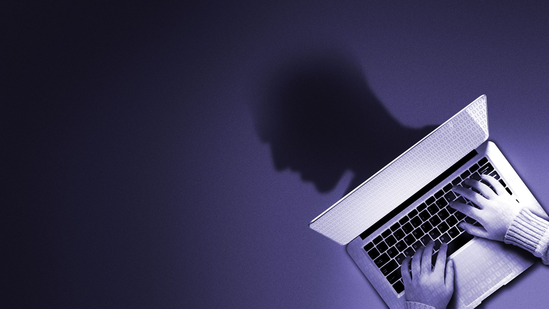 Illustration of a person at a laptop with a shadow of a person's head against a purple background.