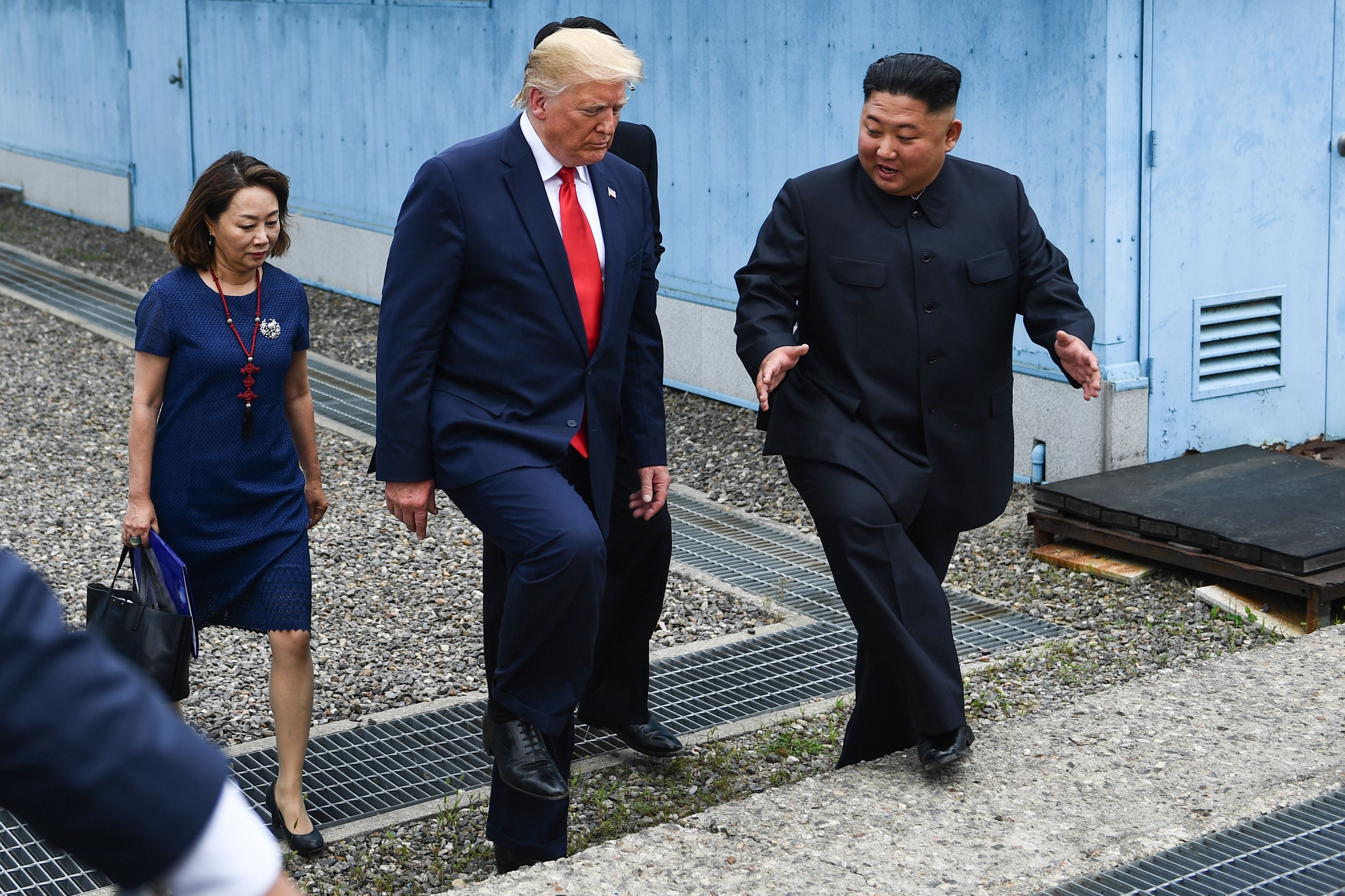 North Korea's leader Kim Jong Un and US President Donald Trump walk together at the DMZ.